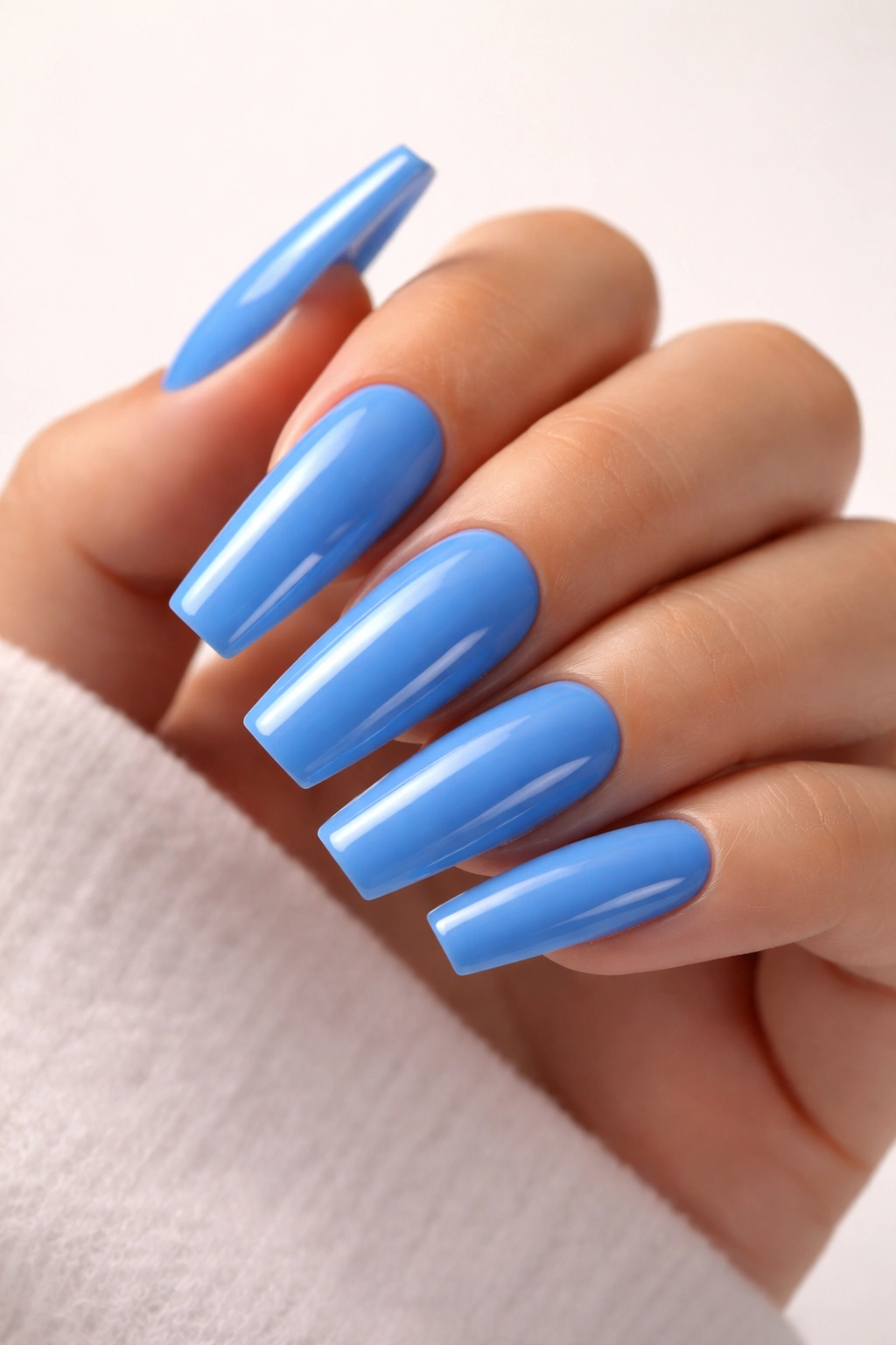 Close-up of blue acrylic nails with pristine finish
