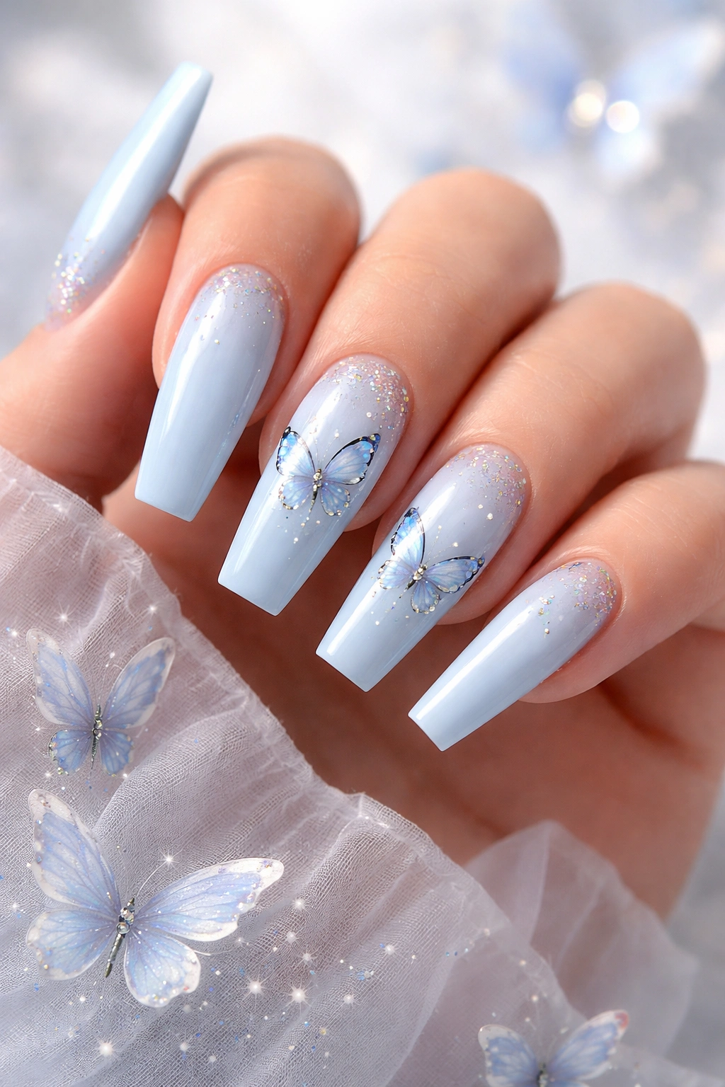 Light blue nails with butterfly accents