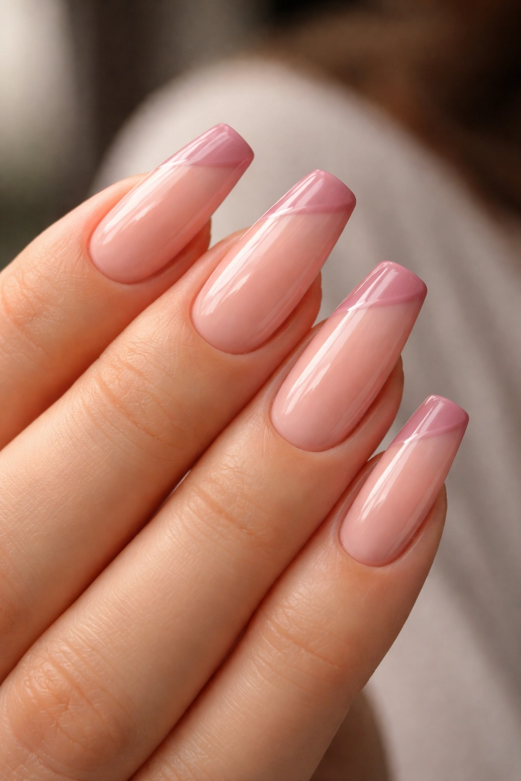 Close-up of angled side French tips in dusty rose on ballerina nails