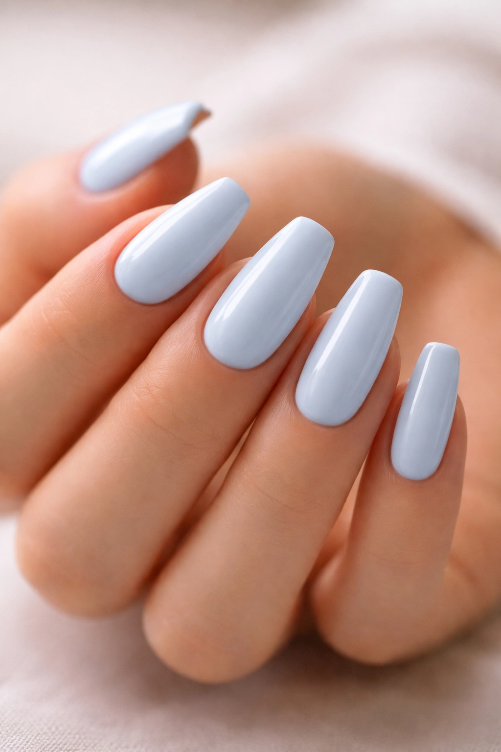 Close-up of medium-length pale blue ballerina nails highlighting tapered shape