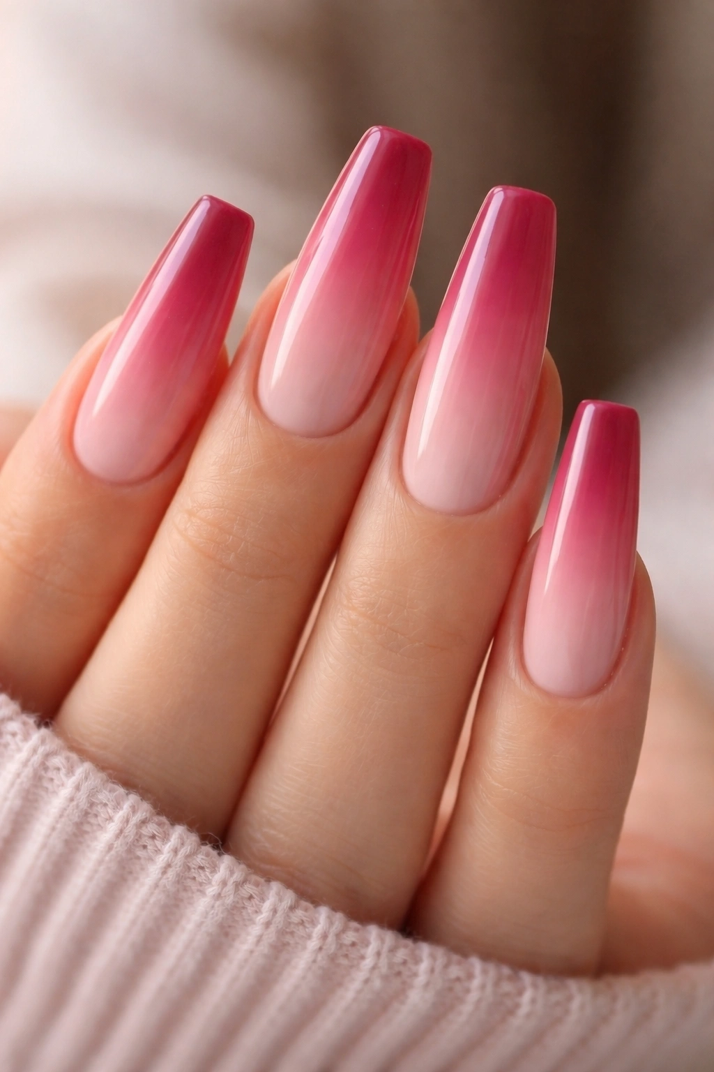 Close-up of long ballerina nails with berry pink to soft blush ombre