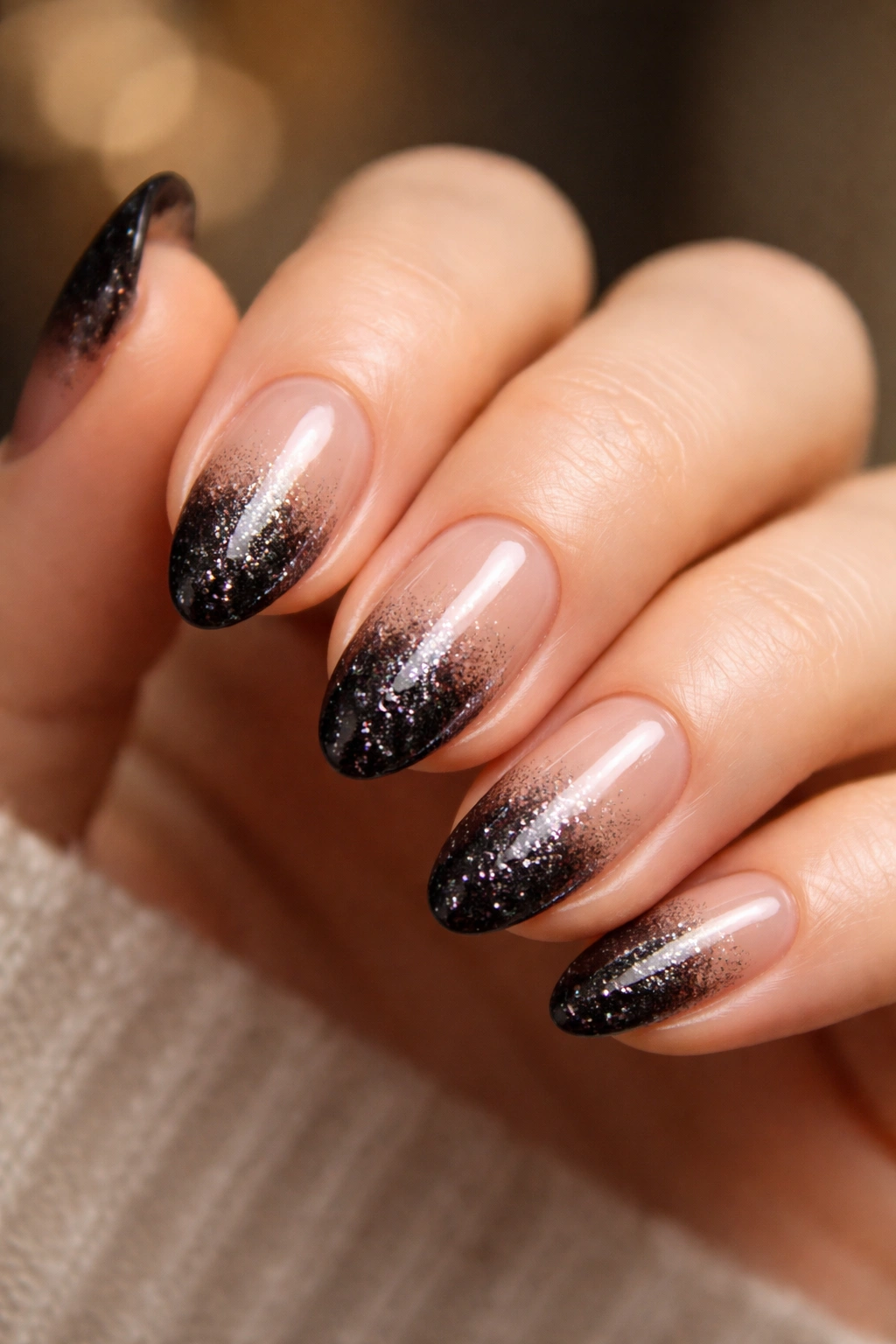 Short almond nail with black glitter fade at the tip