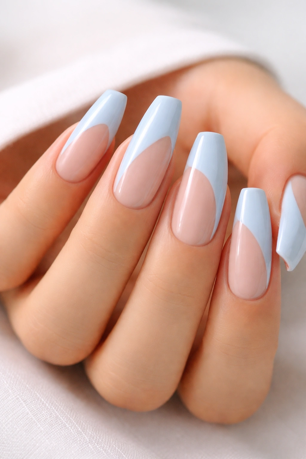 Nails with blue side-swoop negative space on nude base
