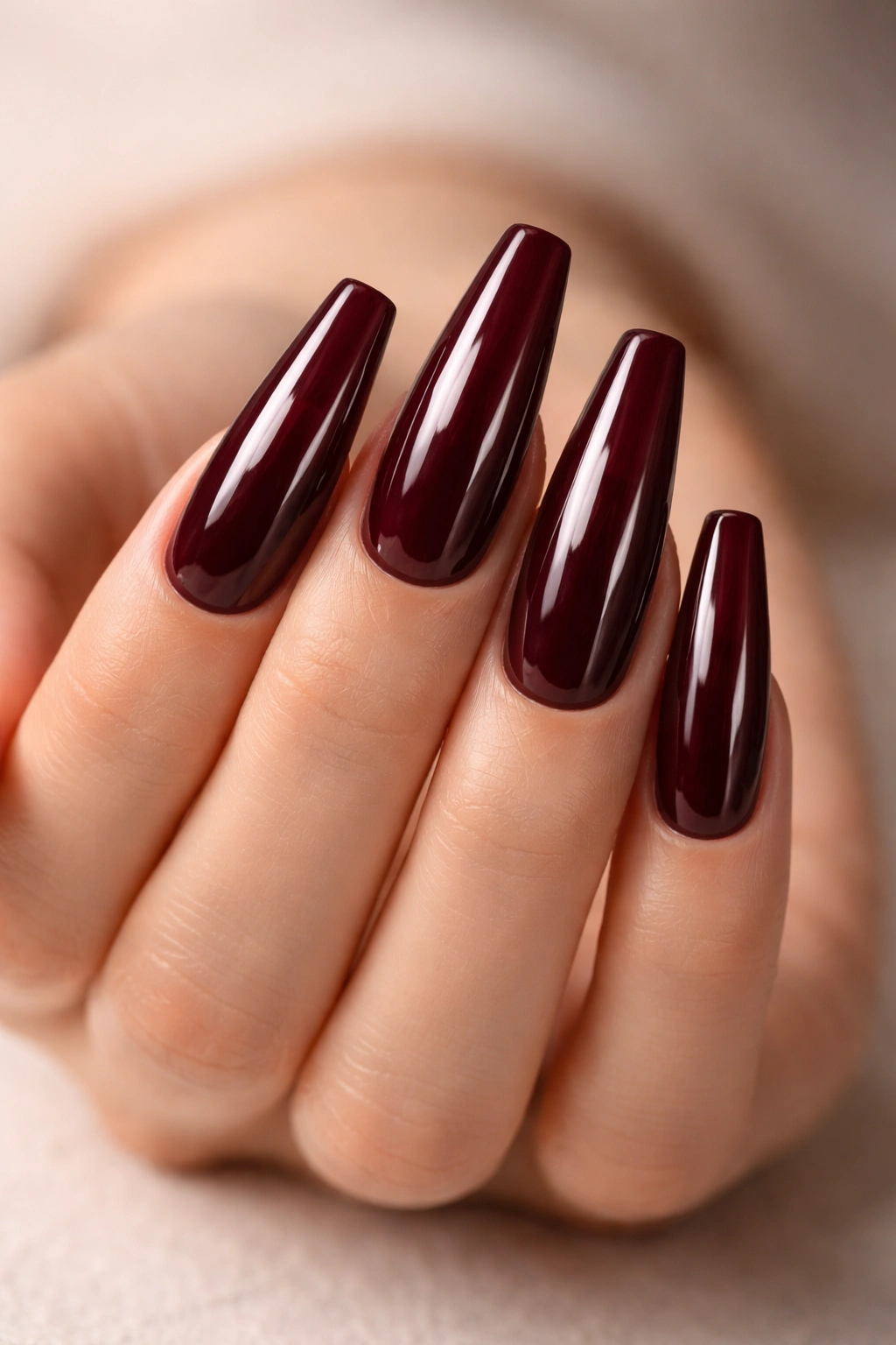 Deep burgundy nails with glass top coat on long ballerina shape