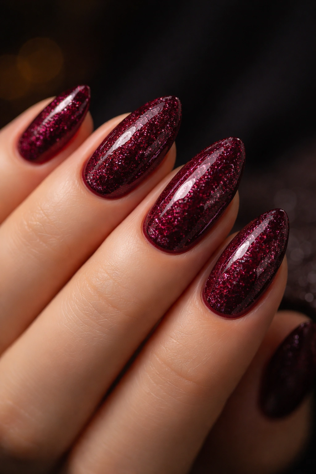 Burgundy glitter almond nails with glossy finish