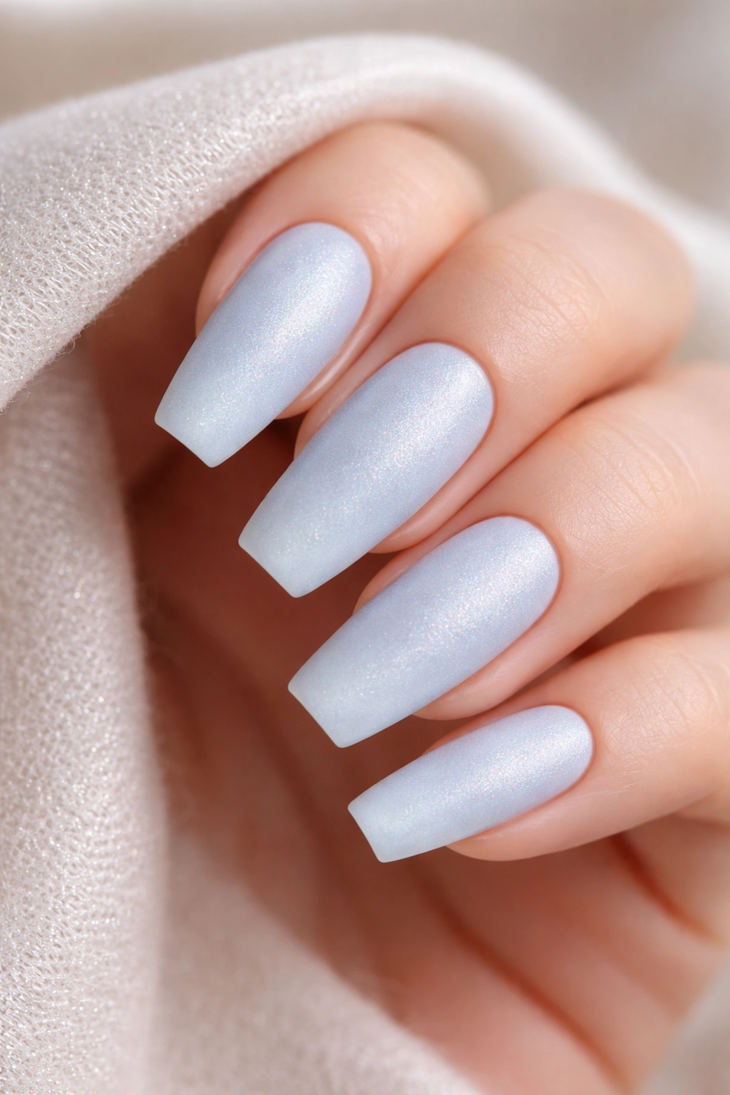Matte blue nails with subtle pearl shimmer resembling cashmere