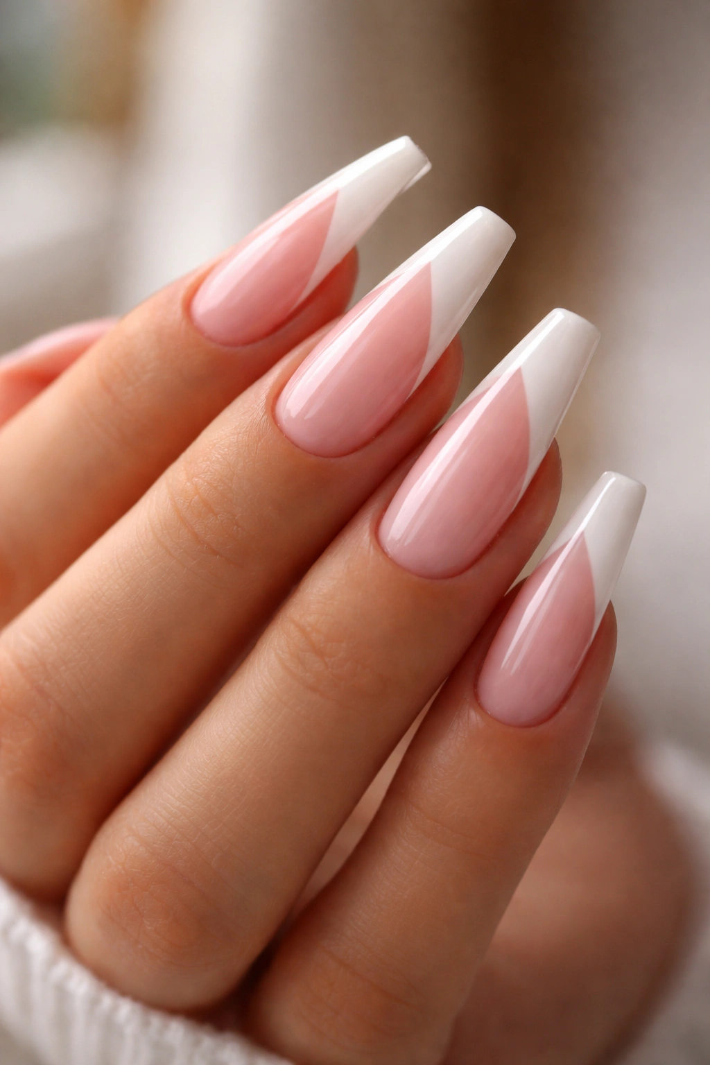 Strawberry-milk pink nails with diagonal French tips on ballerina nails