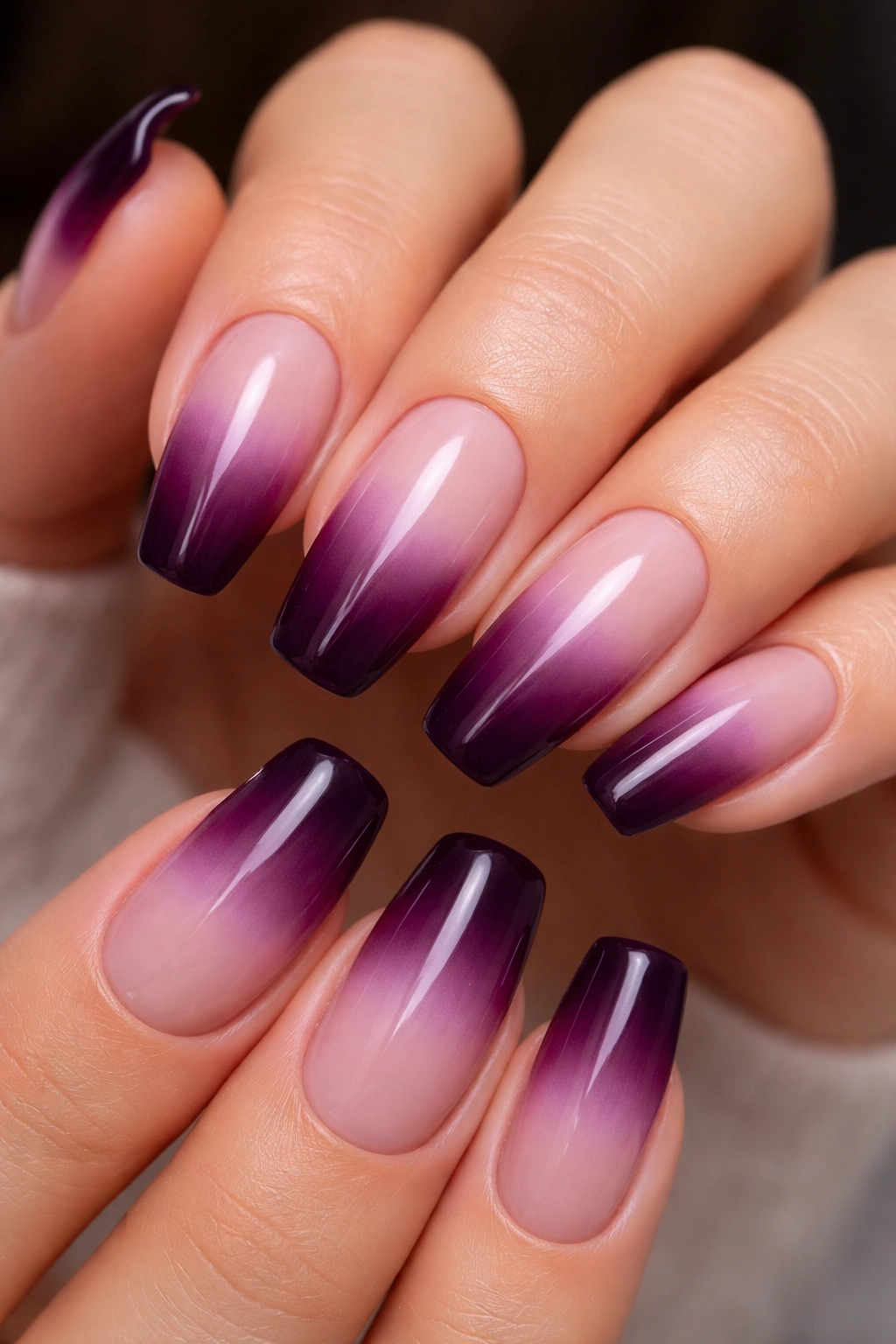 Close-up of eggplant French fade nails showing deep tip and pale base
