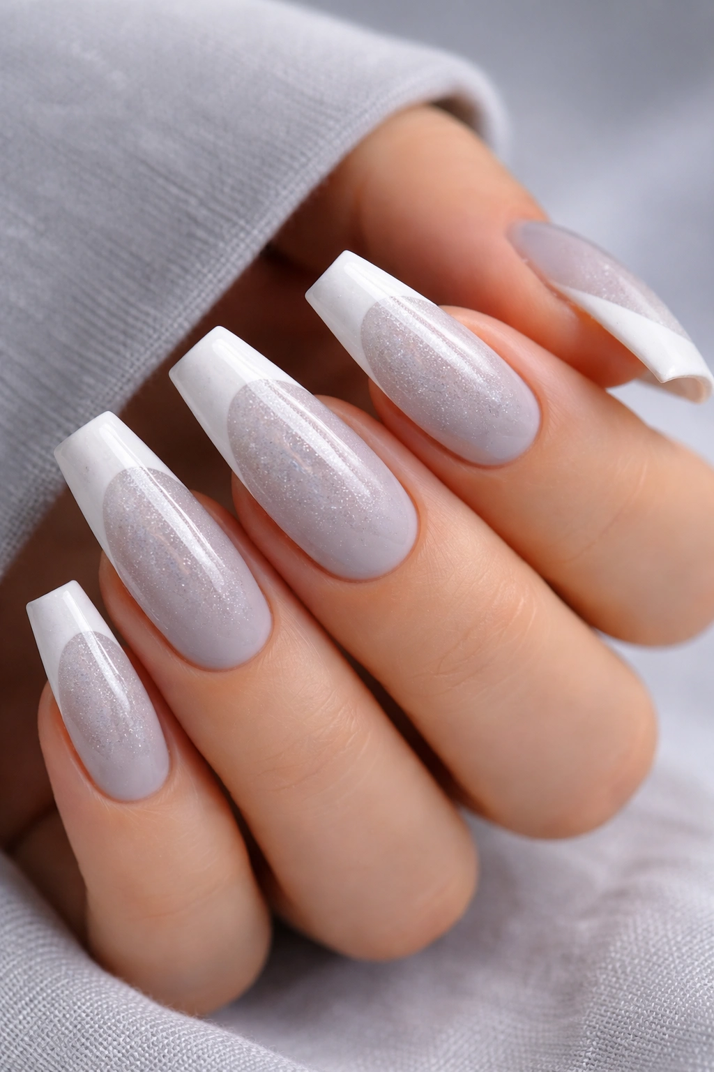 Soft gray nails with white tips and silver shimmer