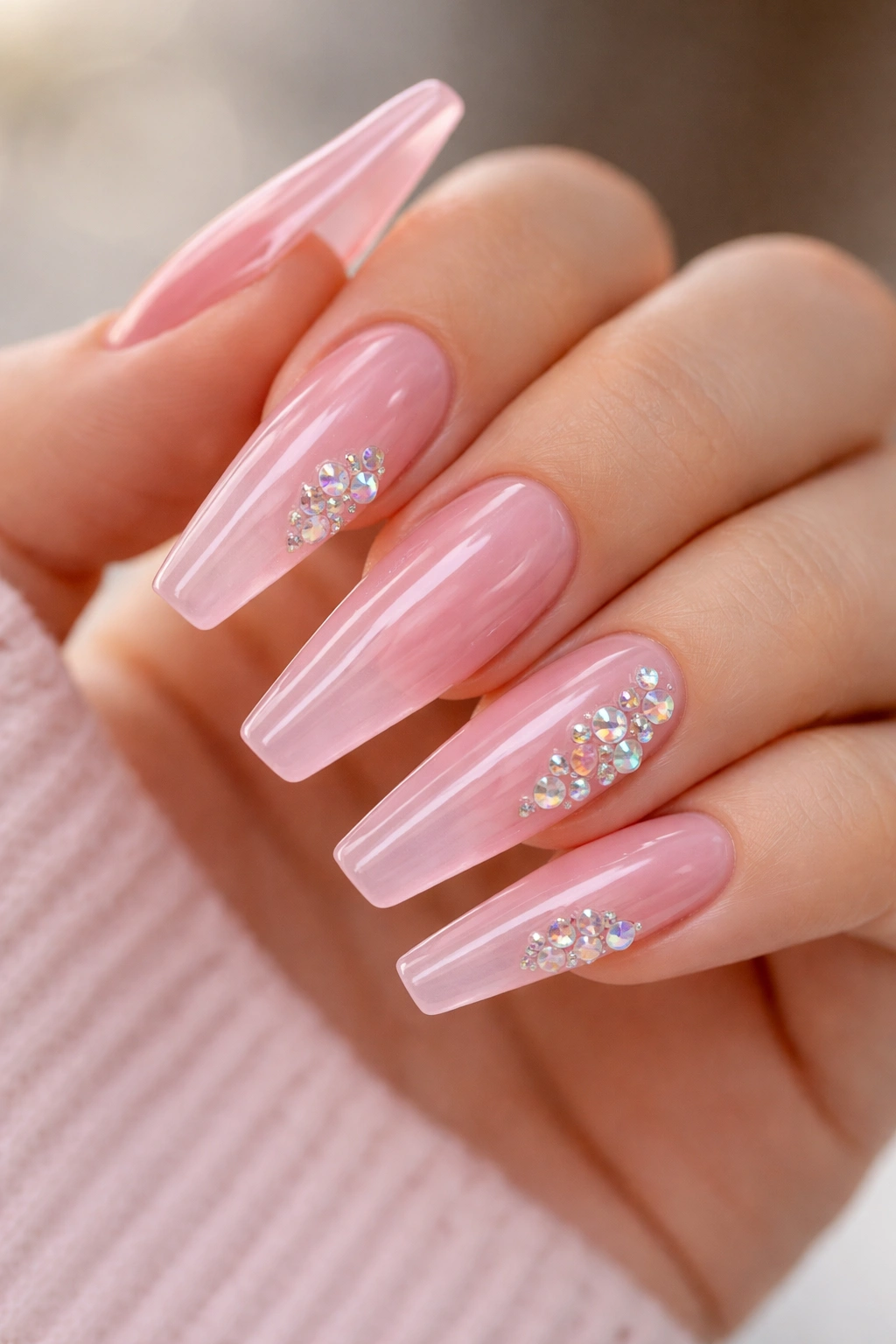 Translucent jelly pink nails with iridescent crystal clusters for playful glow.