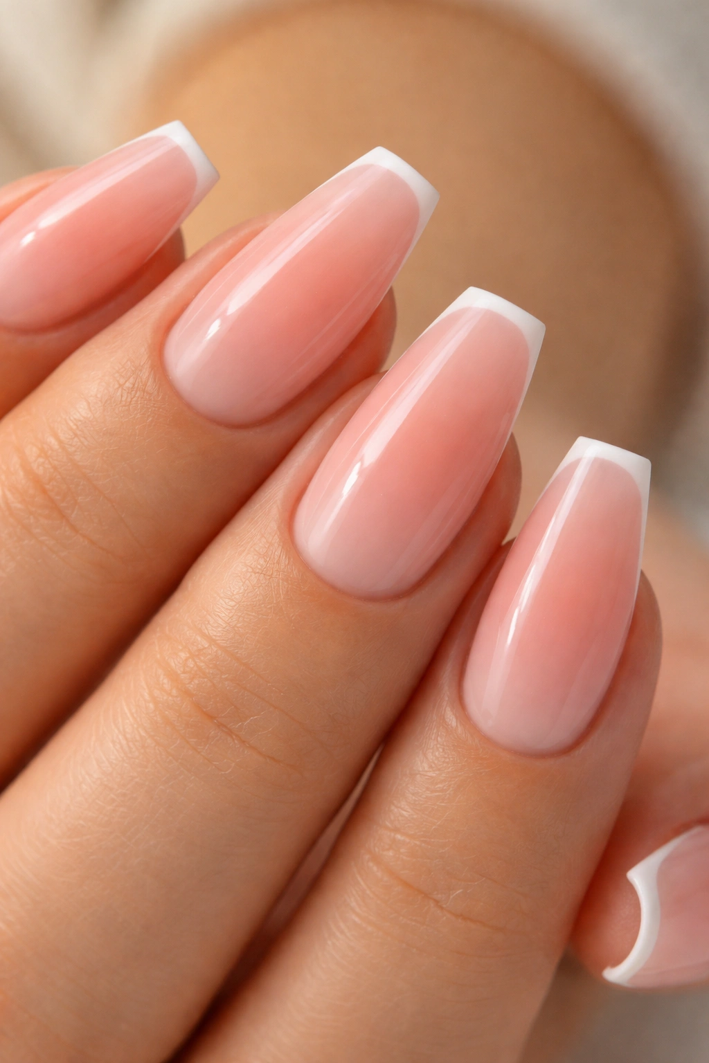 Peach pink ombre nails with an ultra-thin ivory French edge on ballerina nails