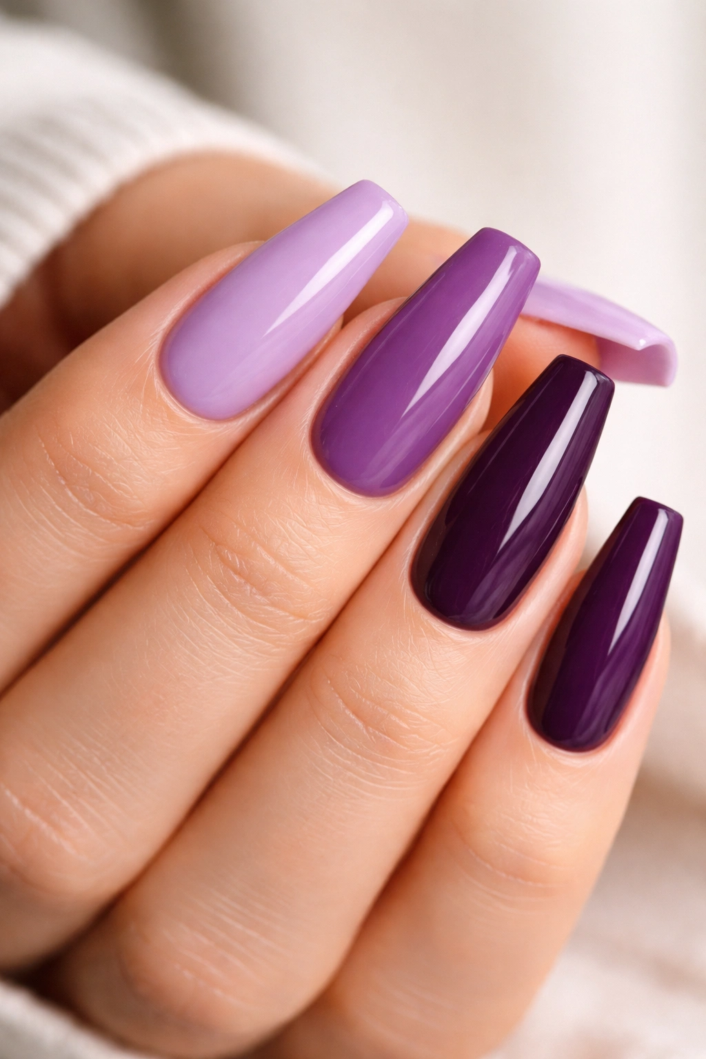 Close-up of purple ballerina nails with crisp edges and pristine polish