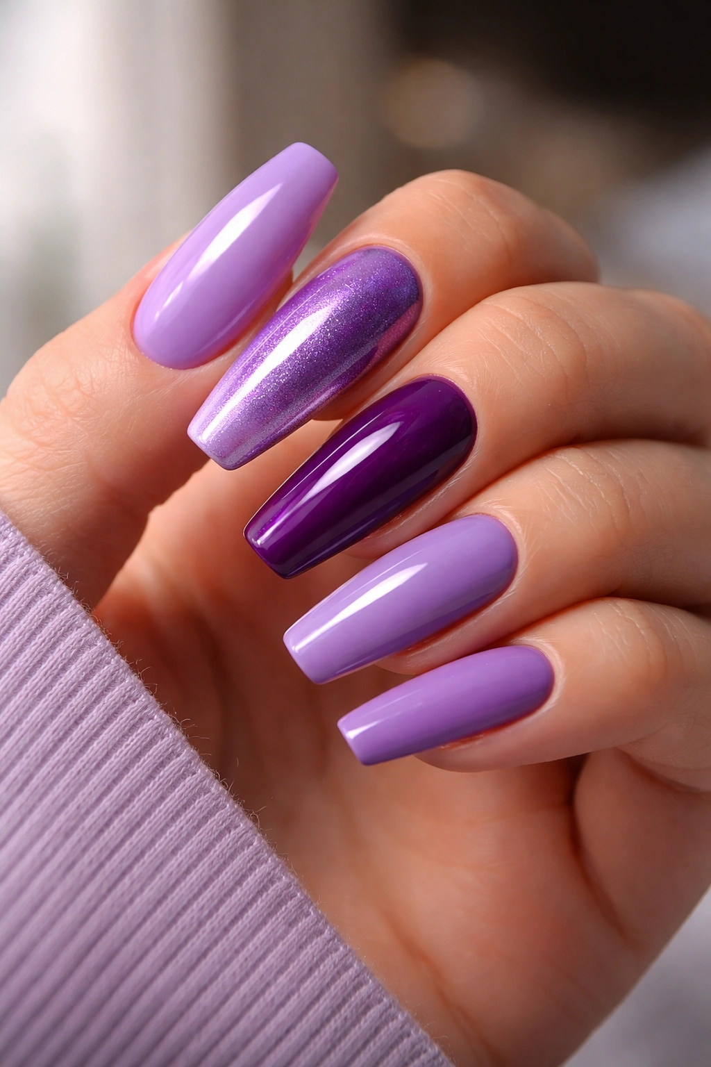 Hand with glossy purple ballerina nails emphasizing finish as a design decision.