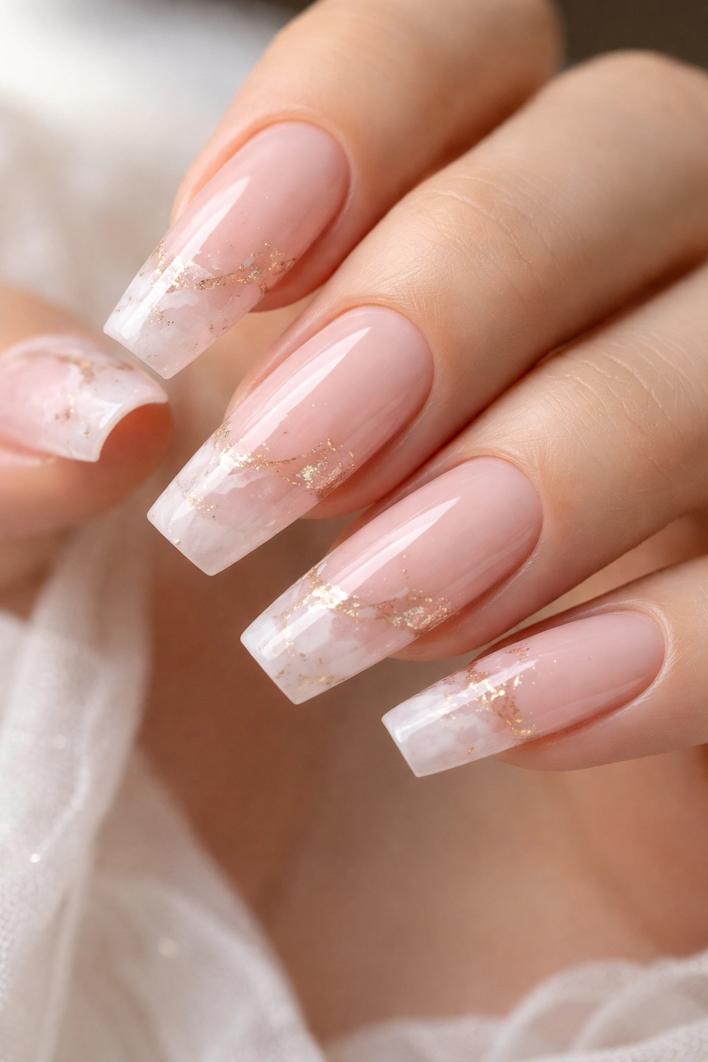 Rose quartz marble French tip on a ballerina nail with wispy veins