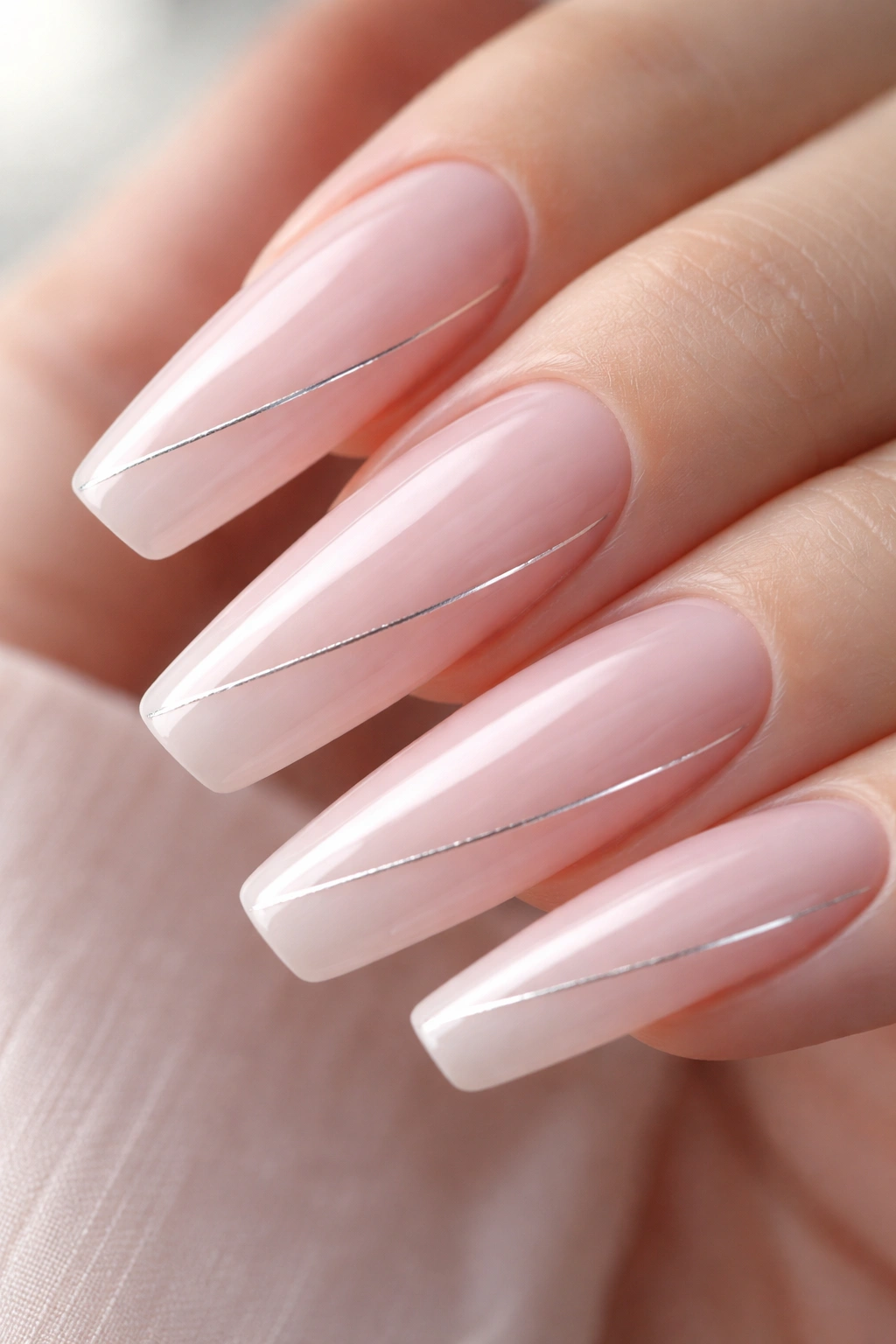 Milky pink nails with a single silver thread line