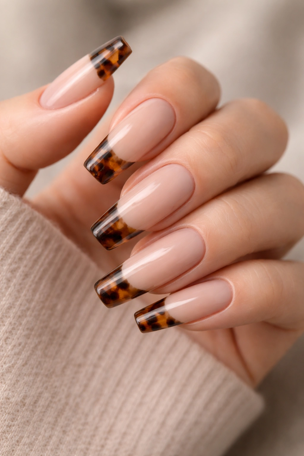 Nude base with tortoiseshell French tips on long ballerina nails