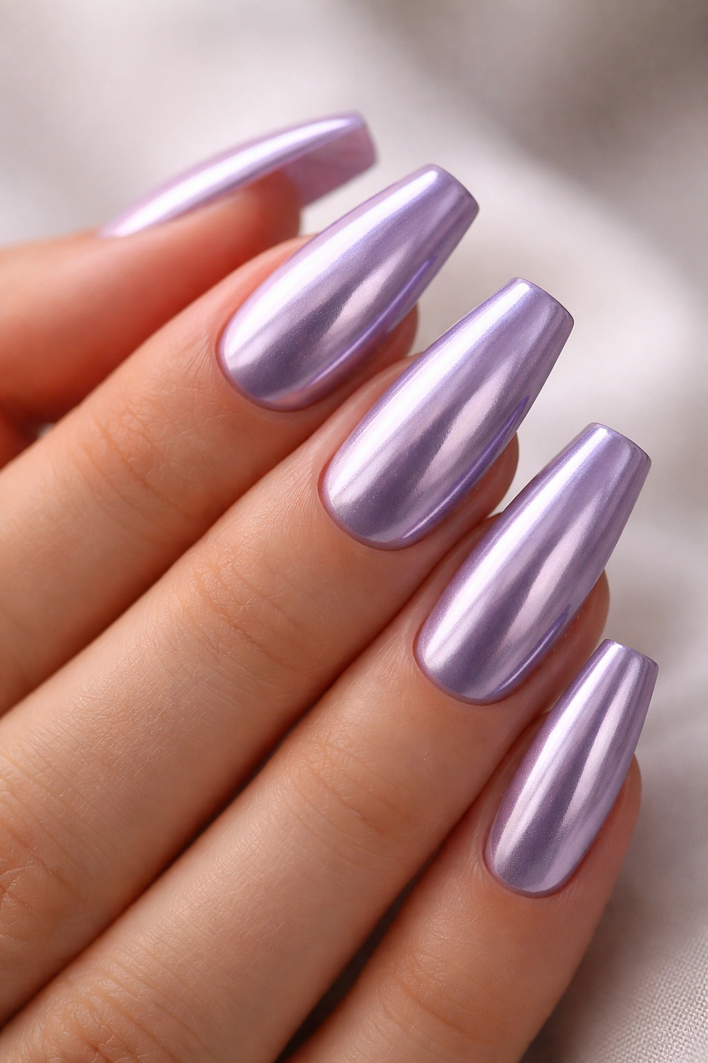 Soft violet chrome nails on ballerina shape with reflective finish.