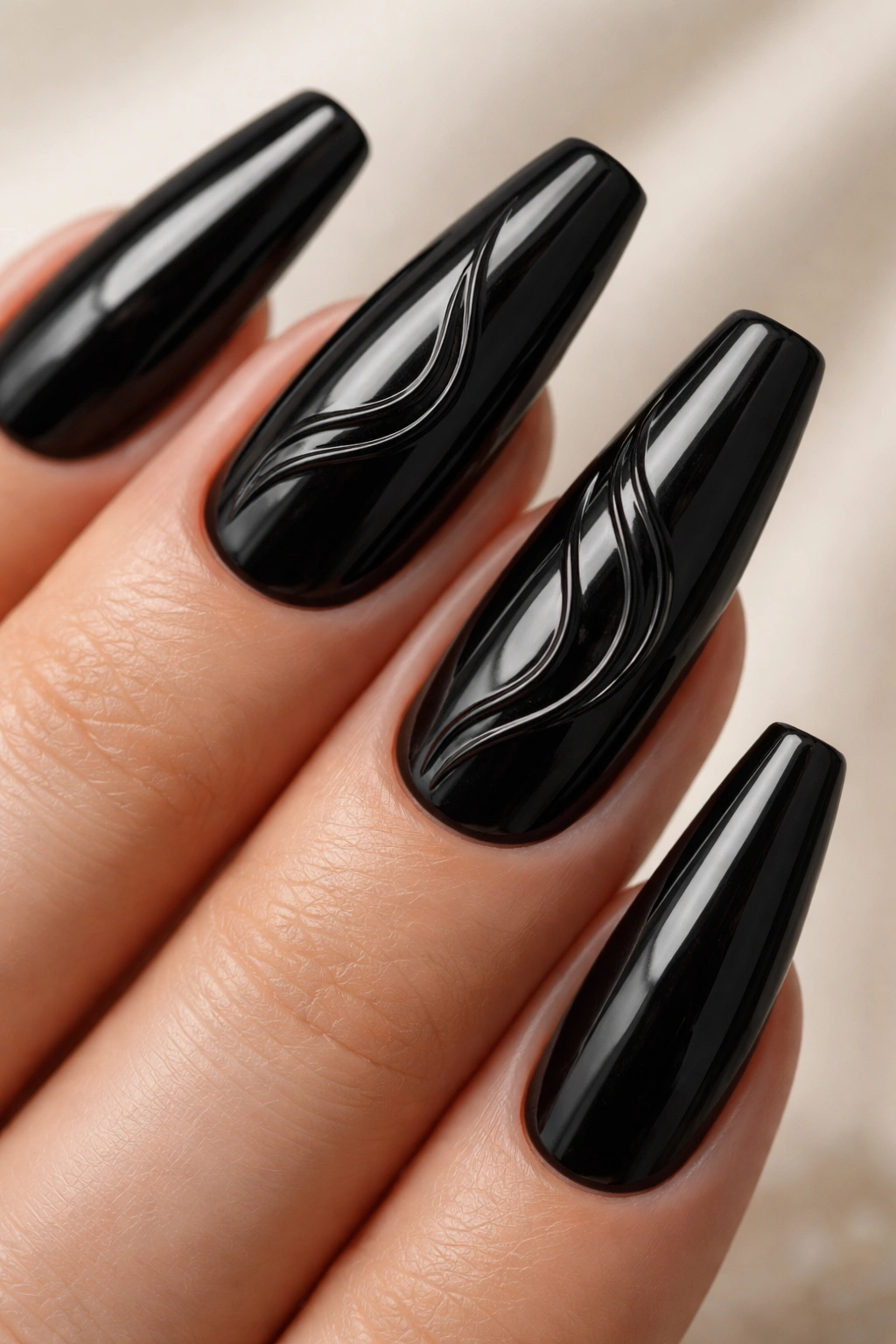 Glossy black nails with raised 3D gel wave accents on ballerina nails