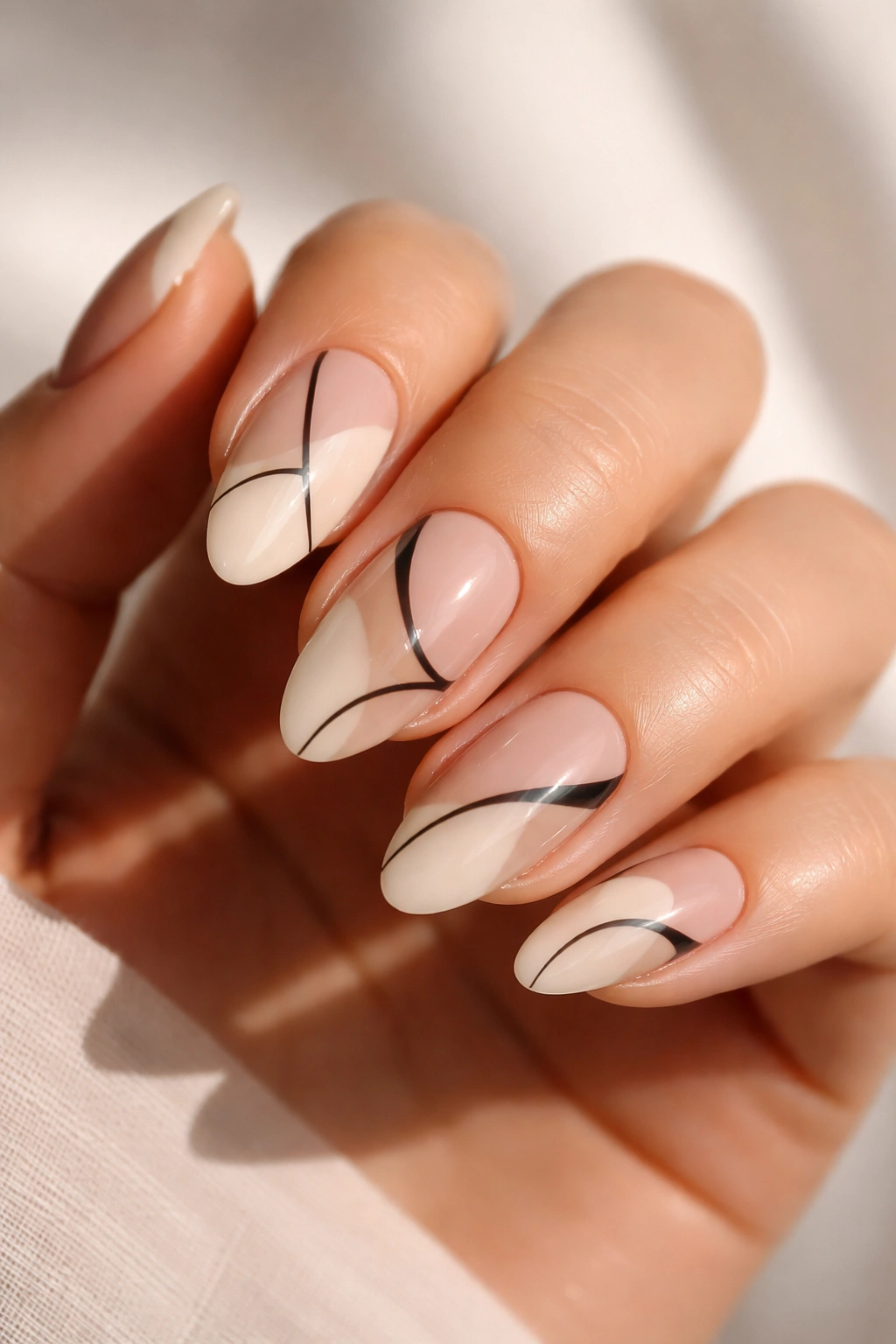 Almond nails with abstract lines and negative-space design