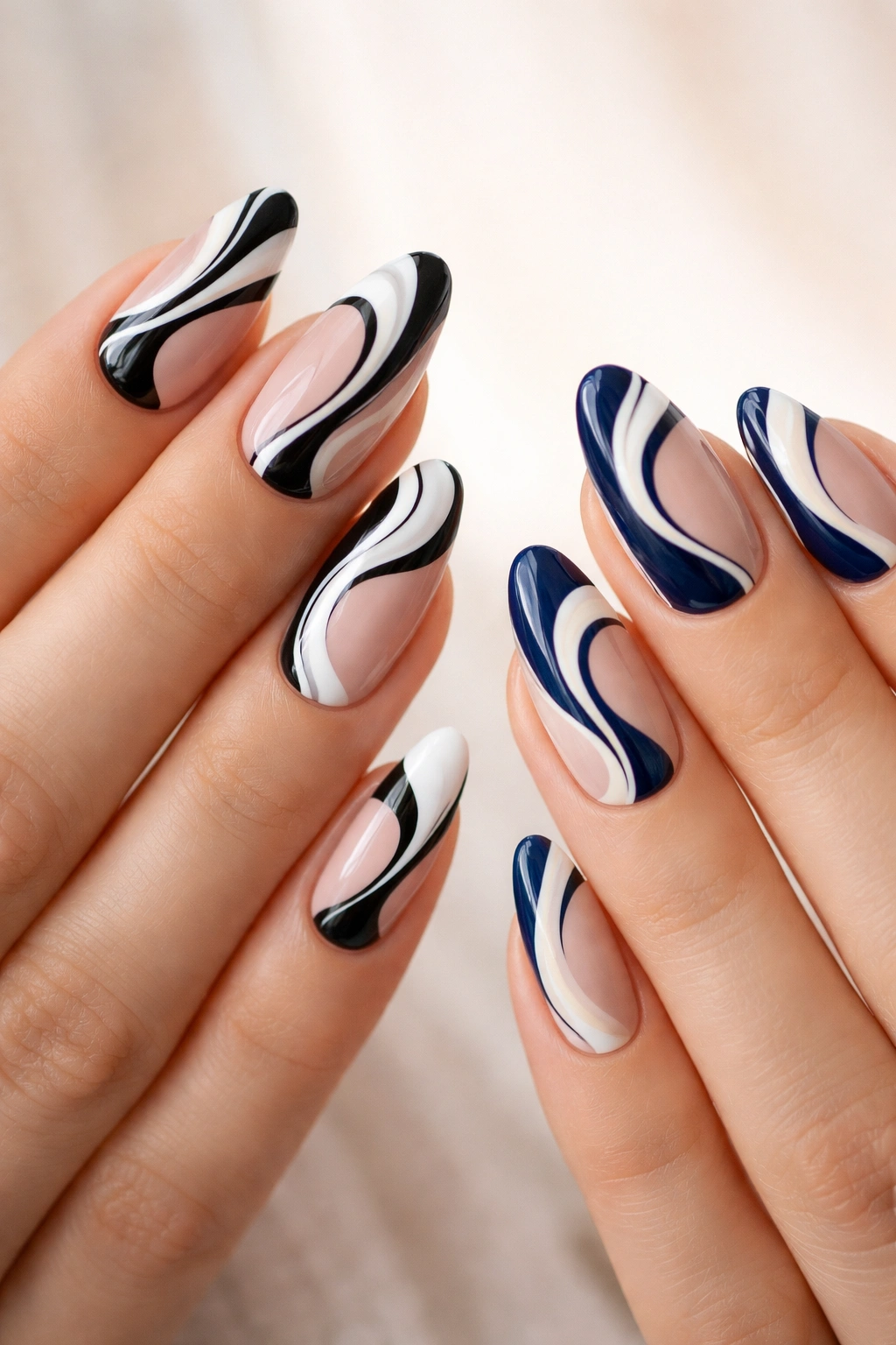 Nails with abstract swirl designs in black/white and navy/cream