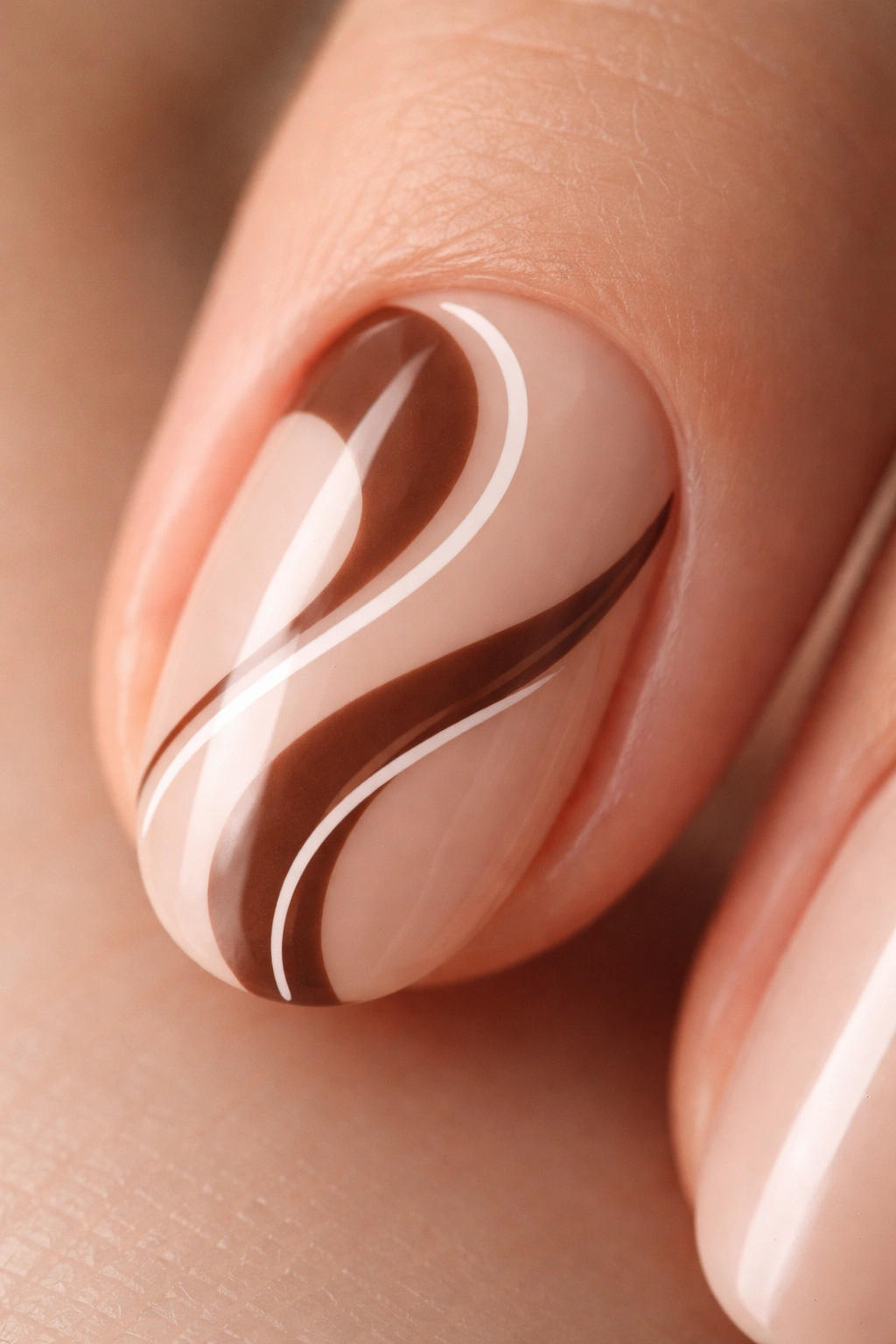 Short oval nail with a brown swirl and a white line on a neutral background