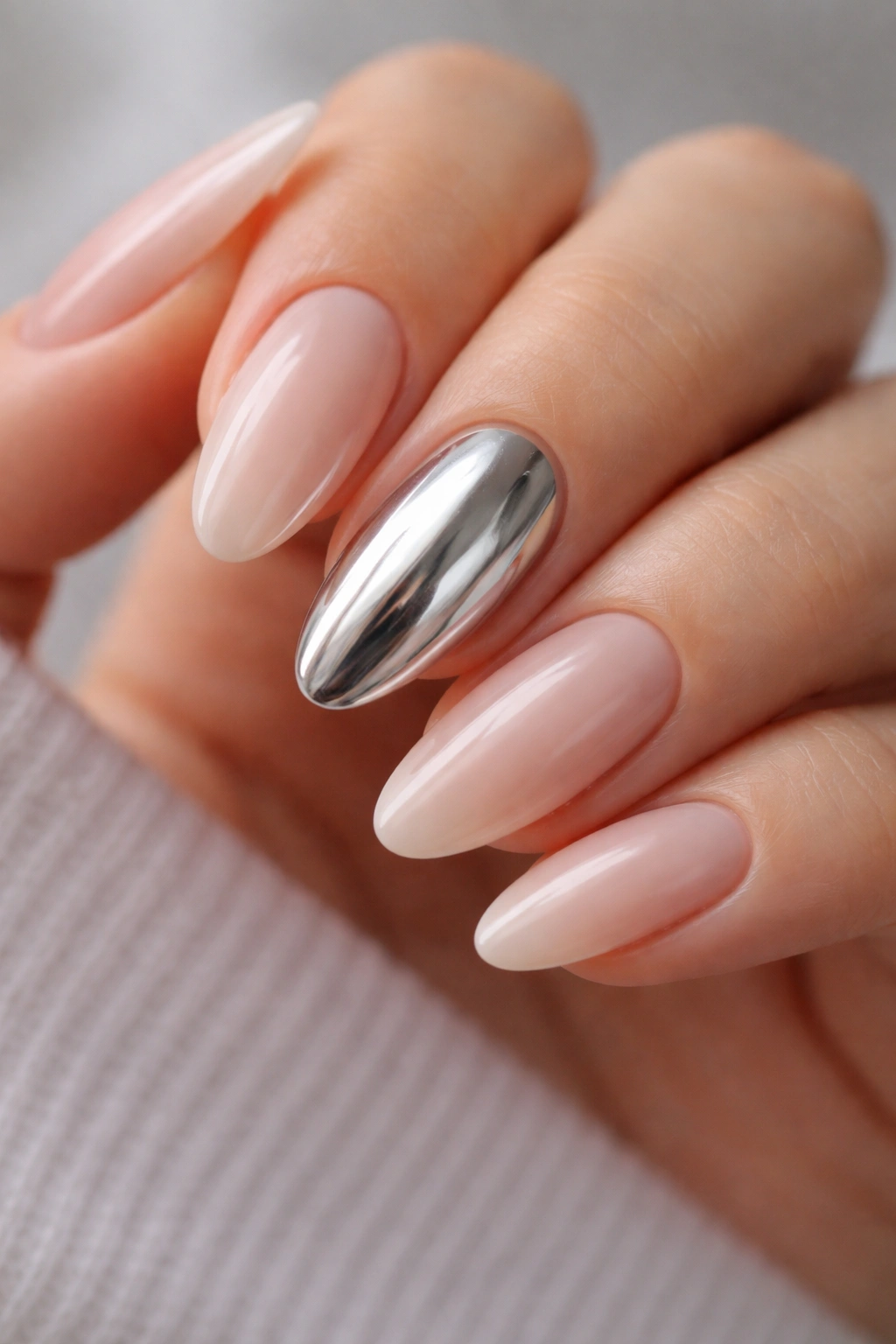 Close-up of nails with chrome accents on almond-shaped nails