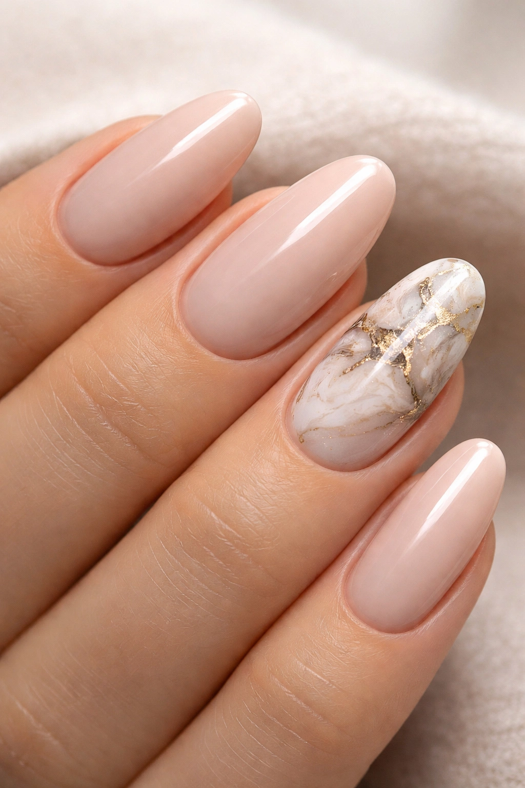 Hand displaying an accent marble nail among solid nails
