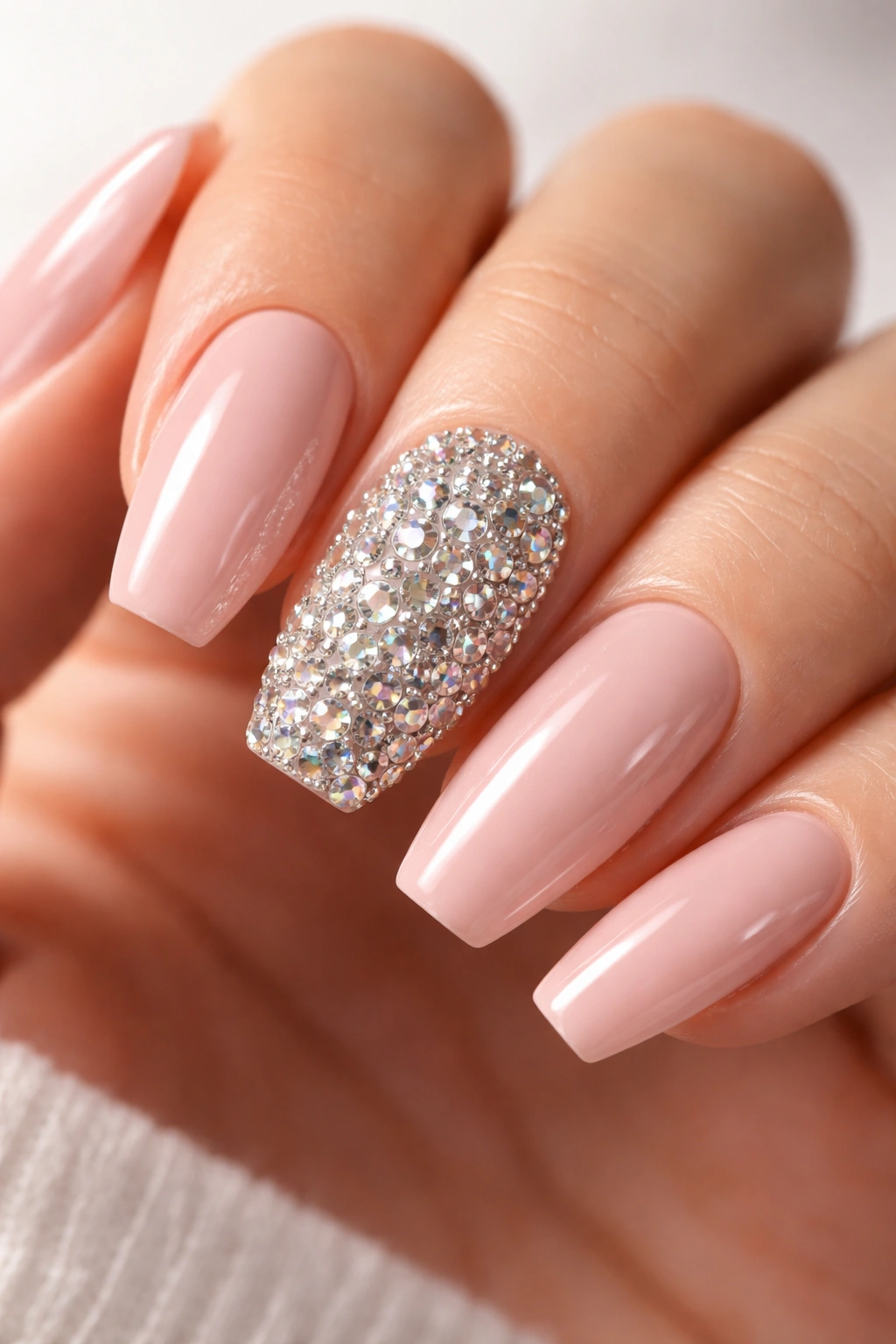 Close-up of rhinestone-encrusted accent nail with solid nails