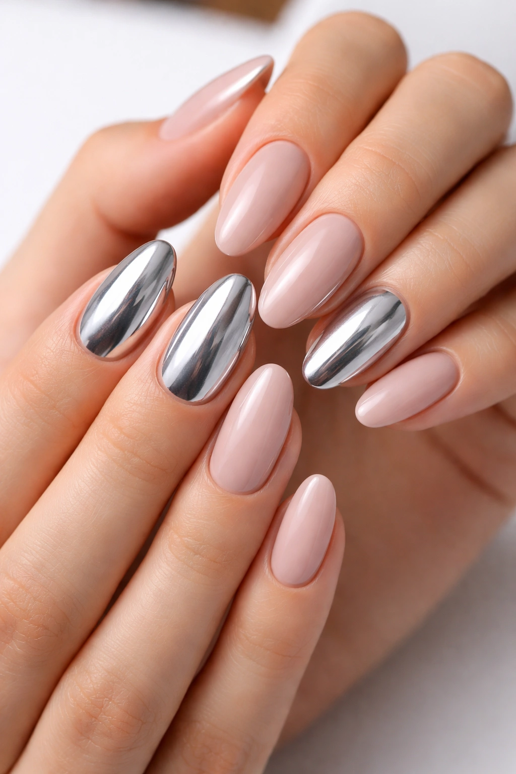 Accent nails in silver chrome against nude nails