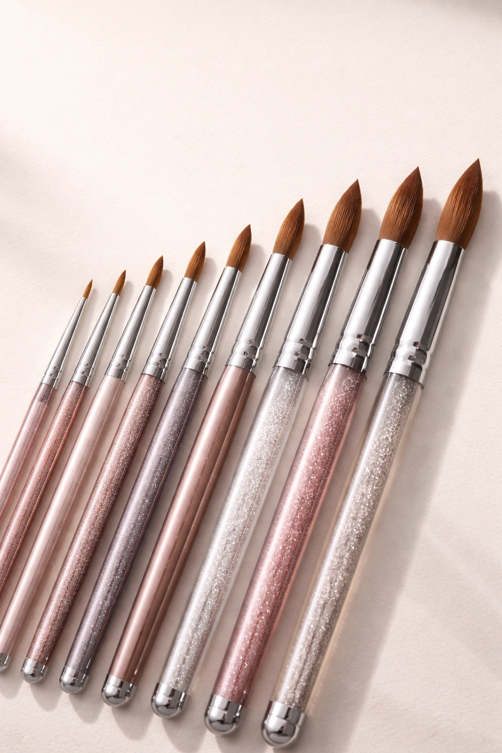 Row of acrylic brushes arranged to illustrate building a brush collection