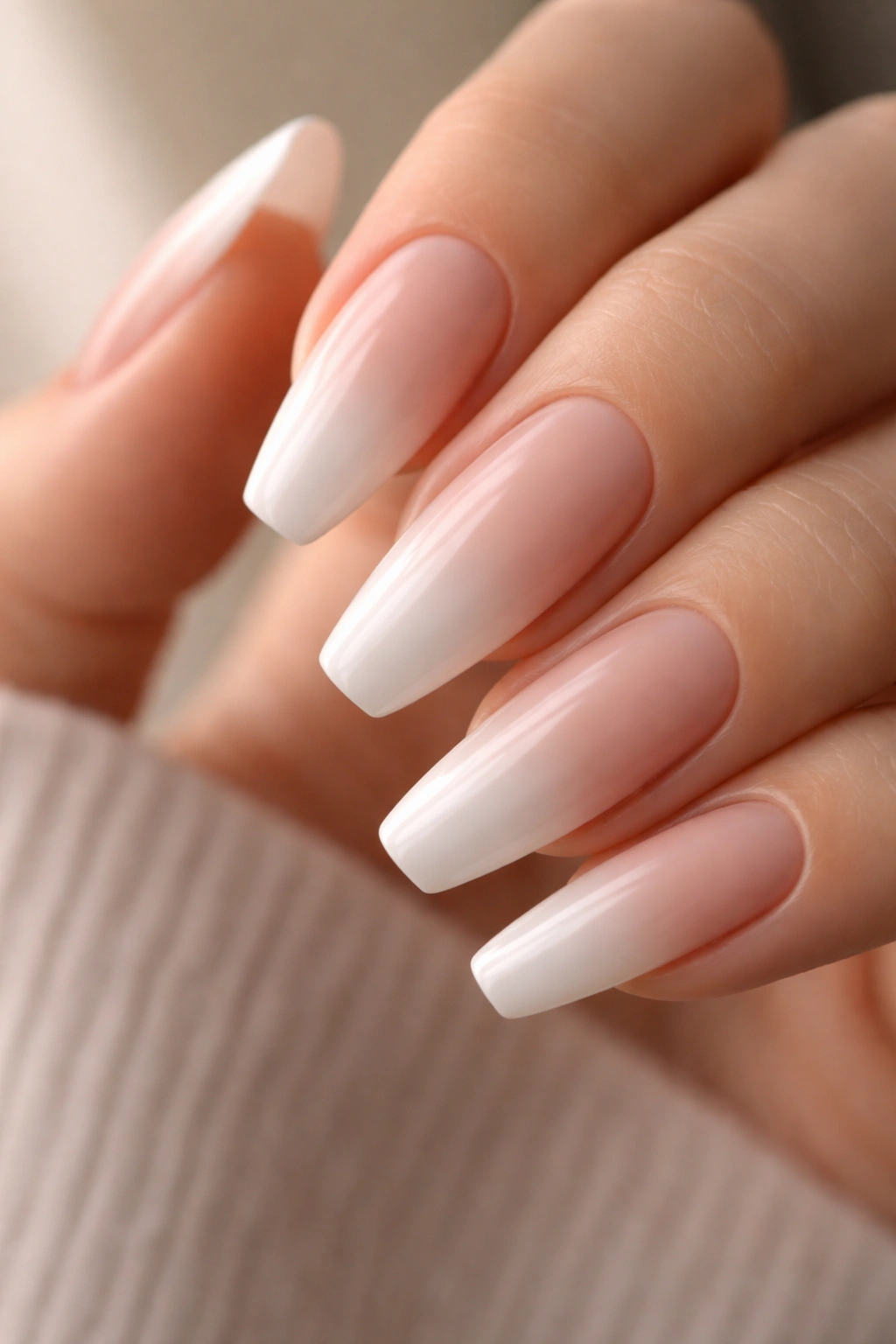 Close-up of airbrushed fade French manicure on ballerina nail