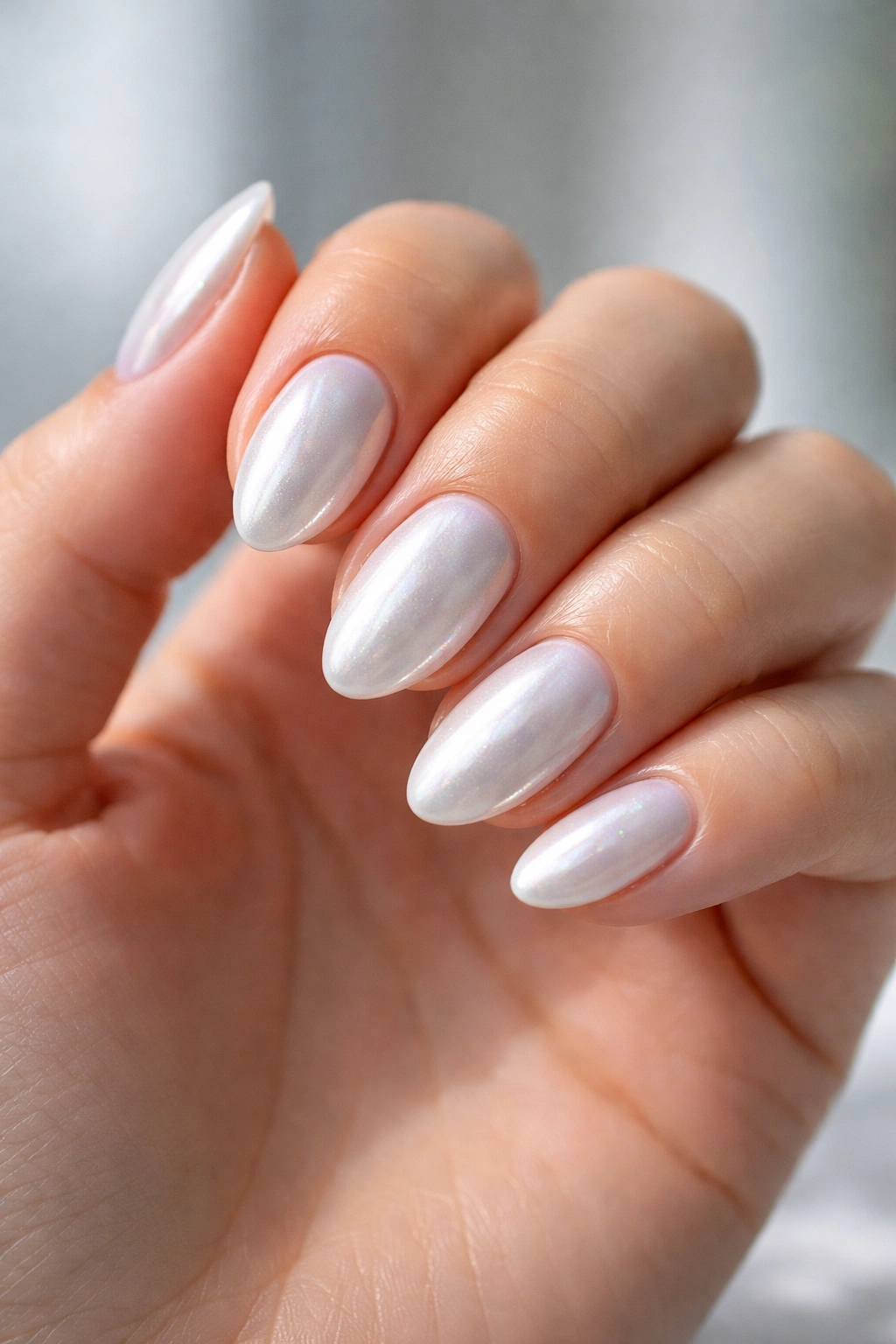 Short almond nails with icy white pearl chrome finish