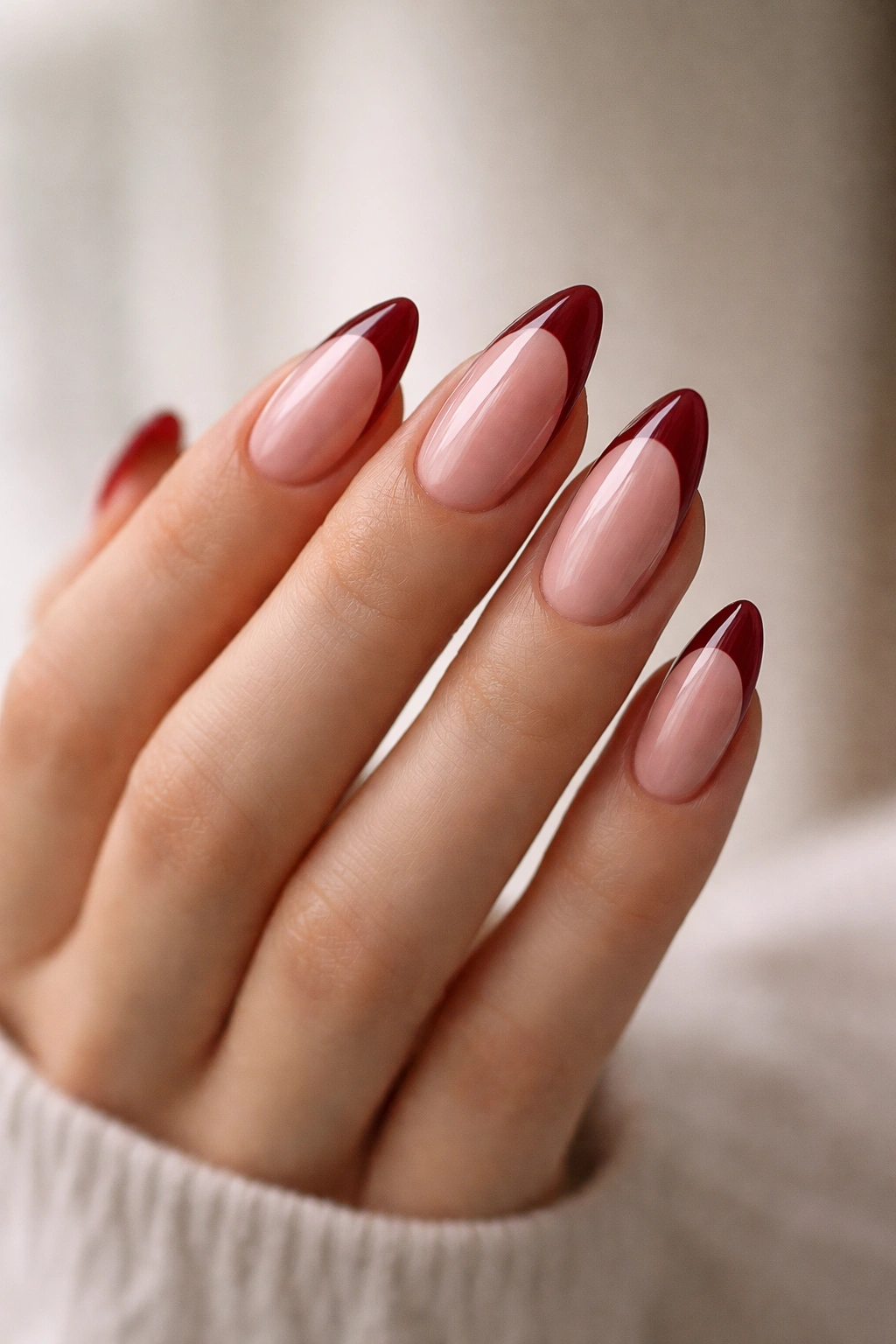 Medium almond-length nails with balanced taper and red French tips