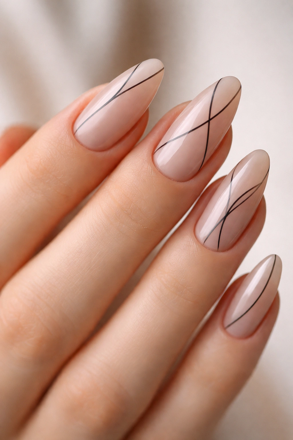 Nude almond nails with minimal black line art