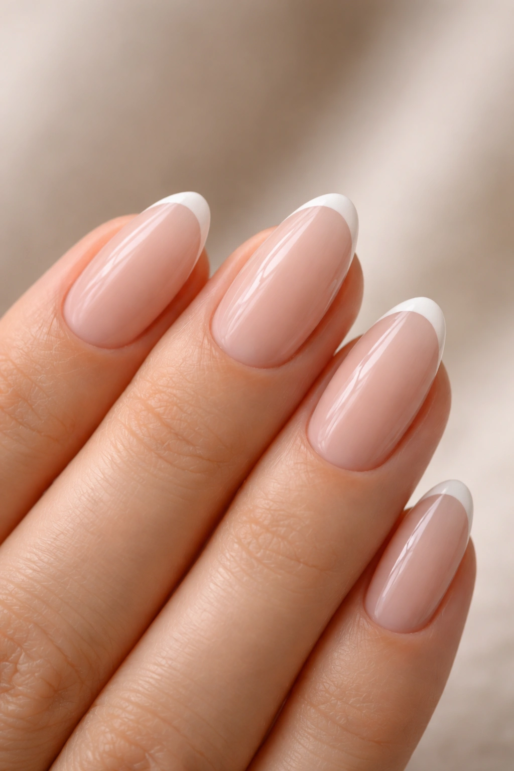 Close-up of almond nails with ultra-thin white micro French tips