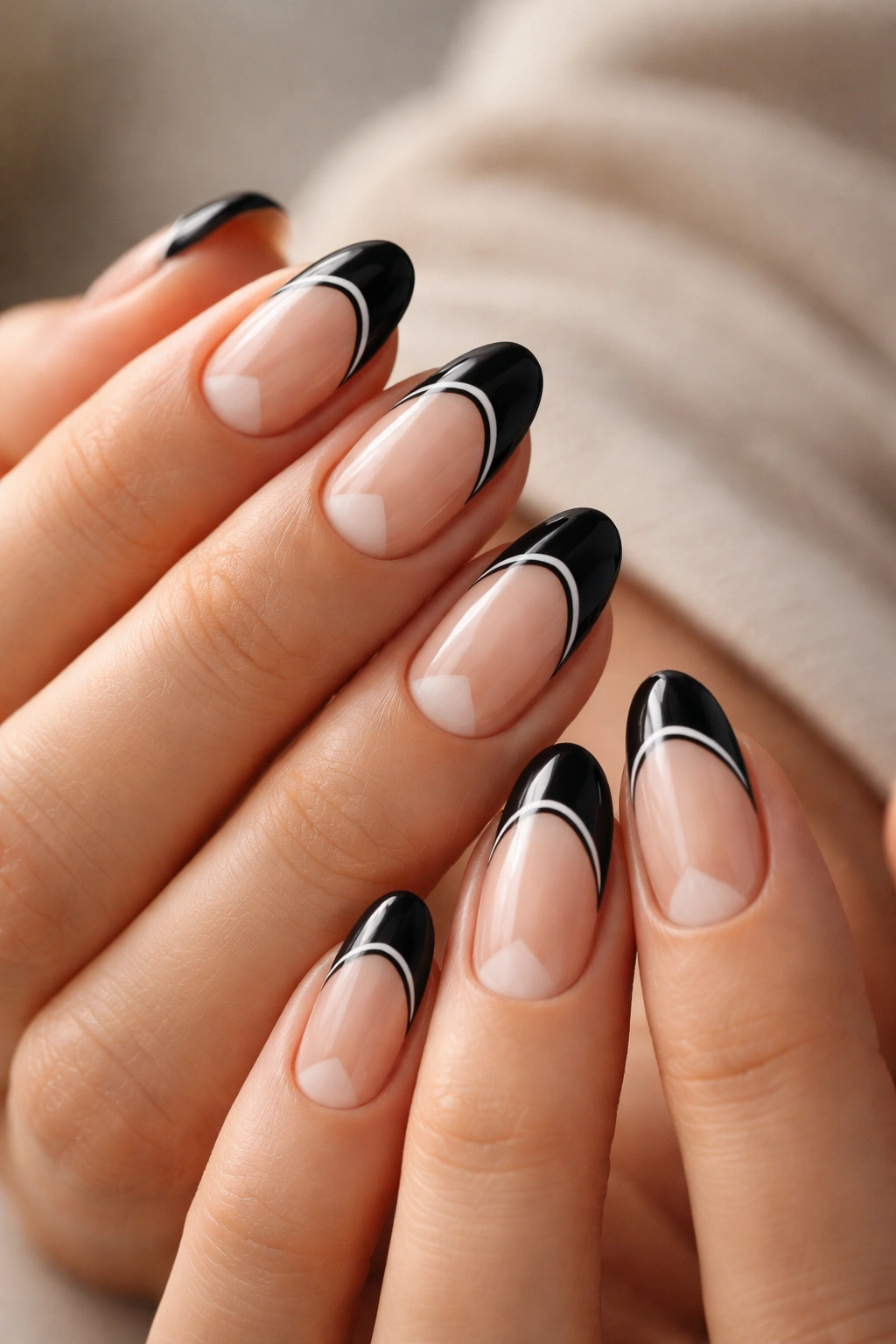 Almond nails with black base, white tips, and negative-space gaps