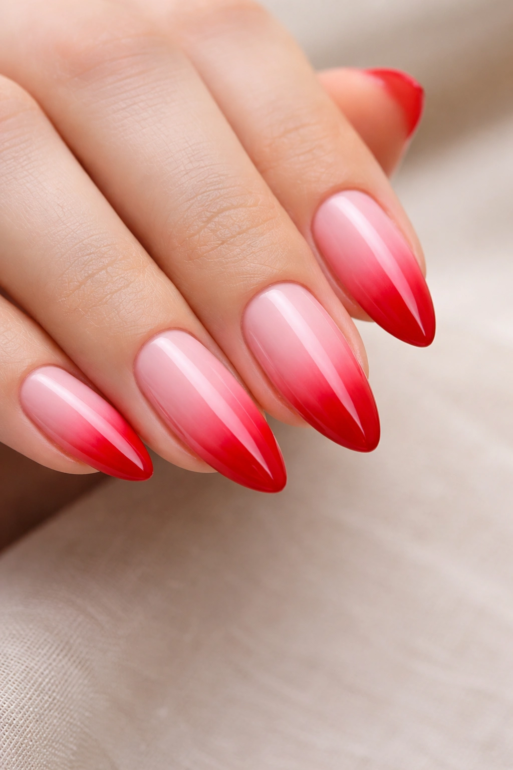 Almond nails with pink to red ombre gradient