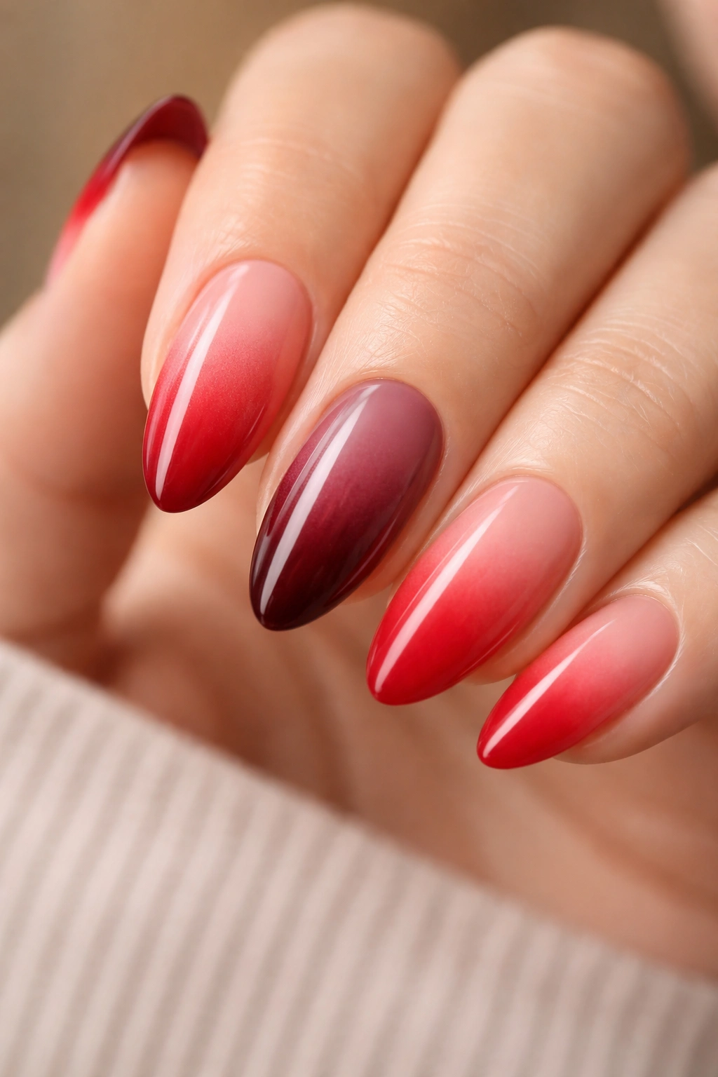 Almond nails showing three red ombre fades