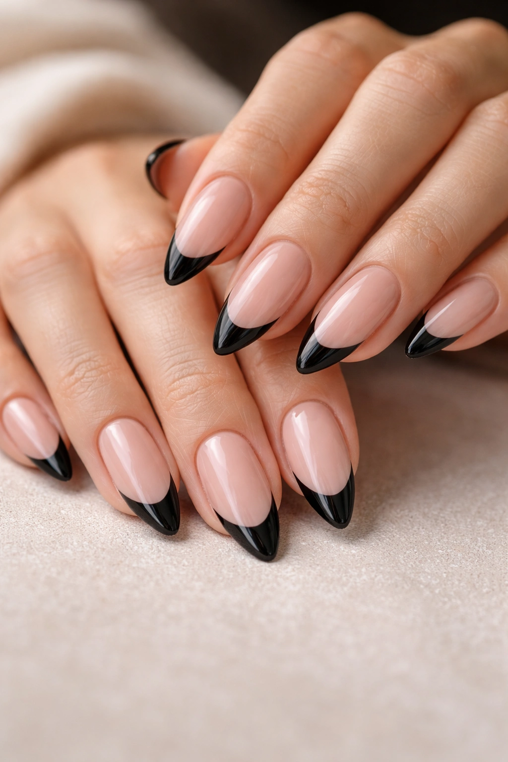 Close-up of almond nails with smooth, tapered tips for clean black tip.