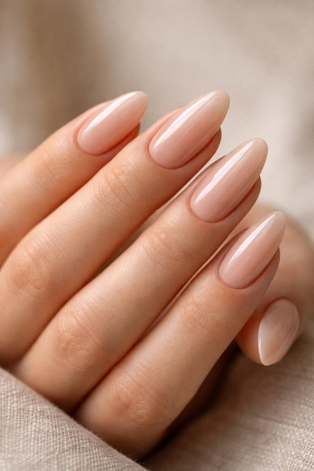 Close-up of almond nails with even shape, balanced length, and tidy cuticles