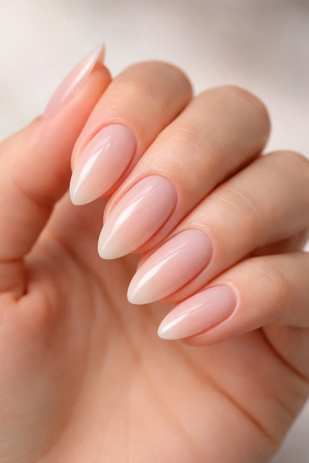 Close-up of almond-shaped nails with tapered sides and rounded tips