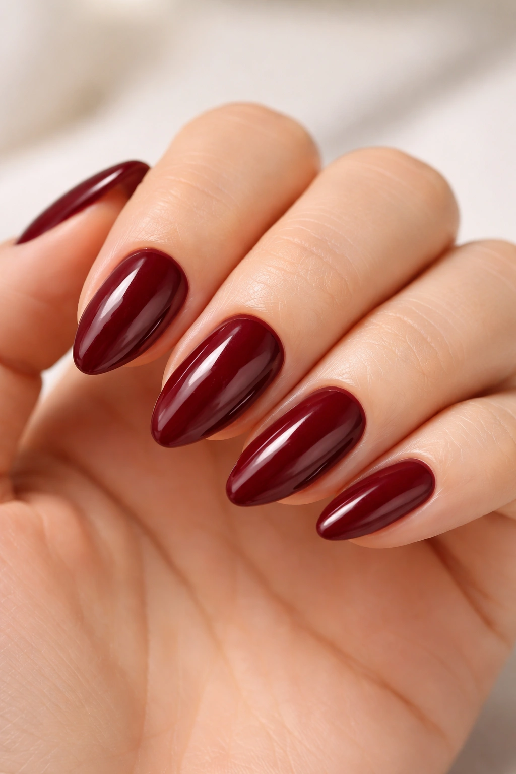 Close-up of short almond nails with base and top coats for lasting polish