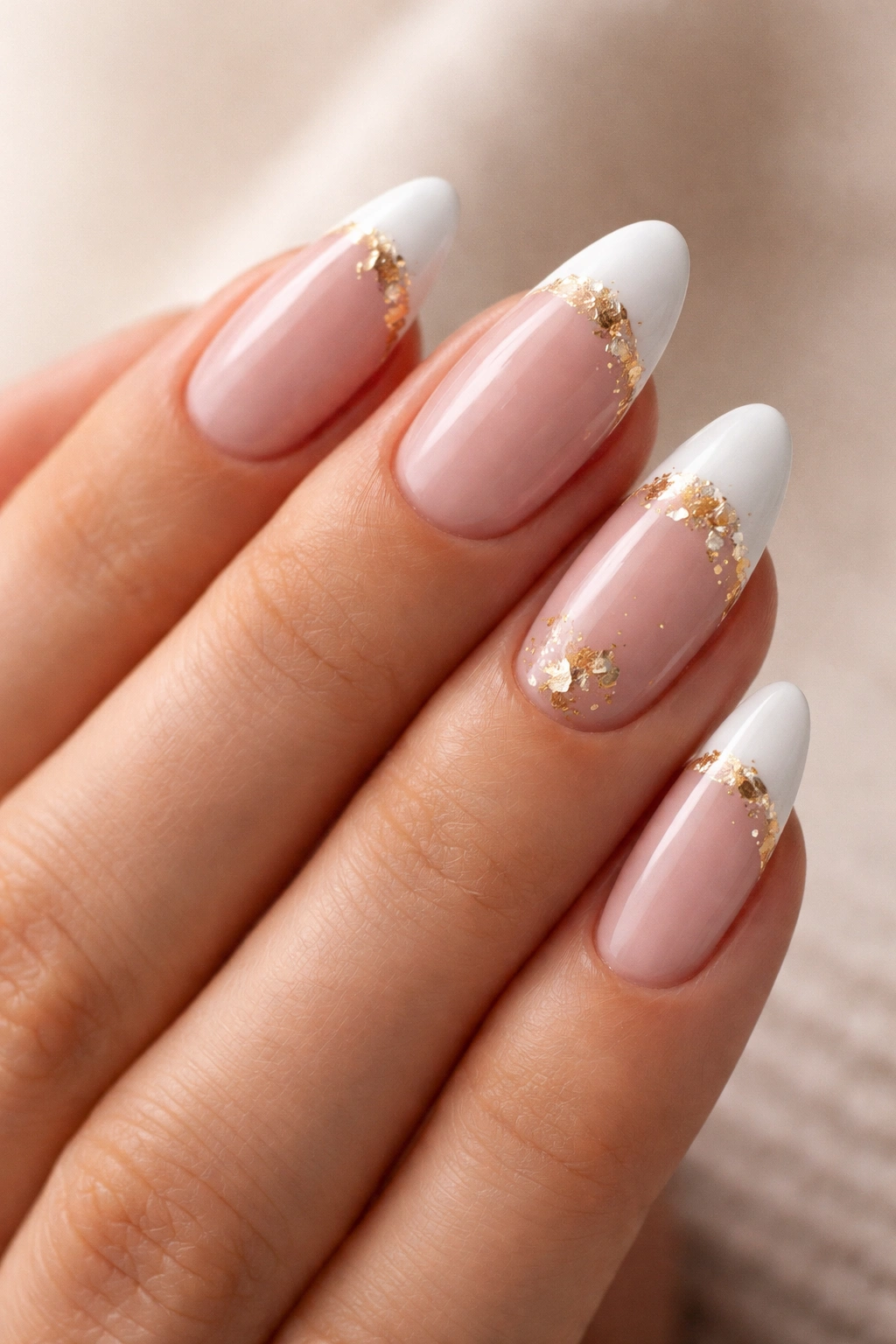 Almond nails with gold foil accents on white French tips