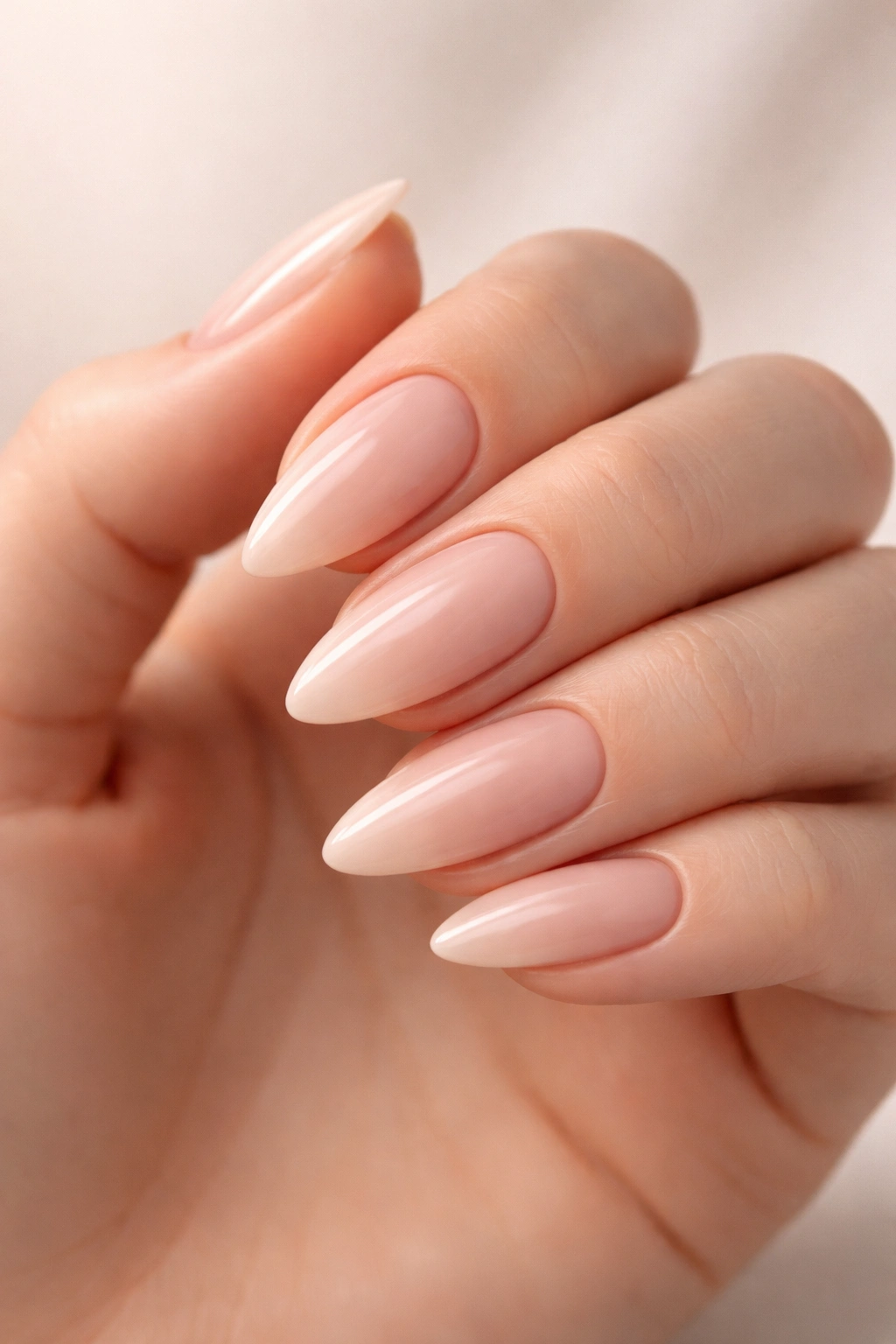 Close-up of almond-shaped nails with a soft point on a hand