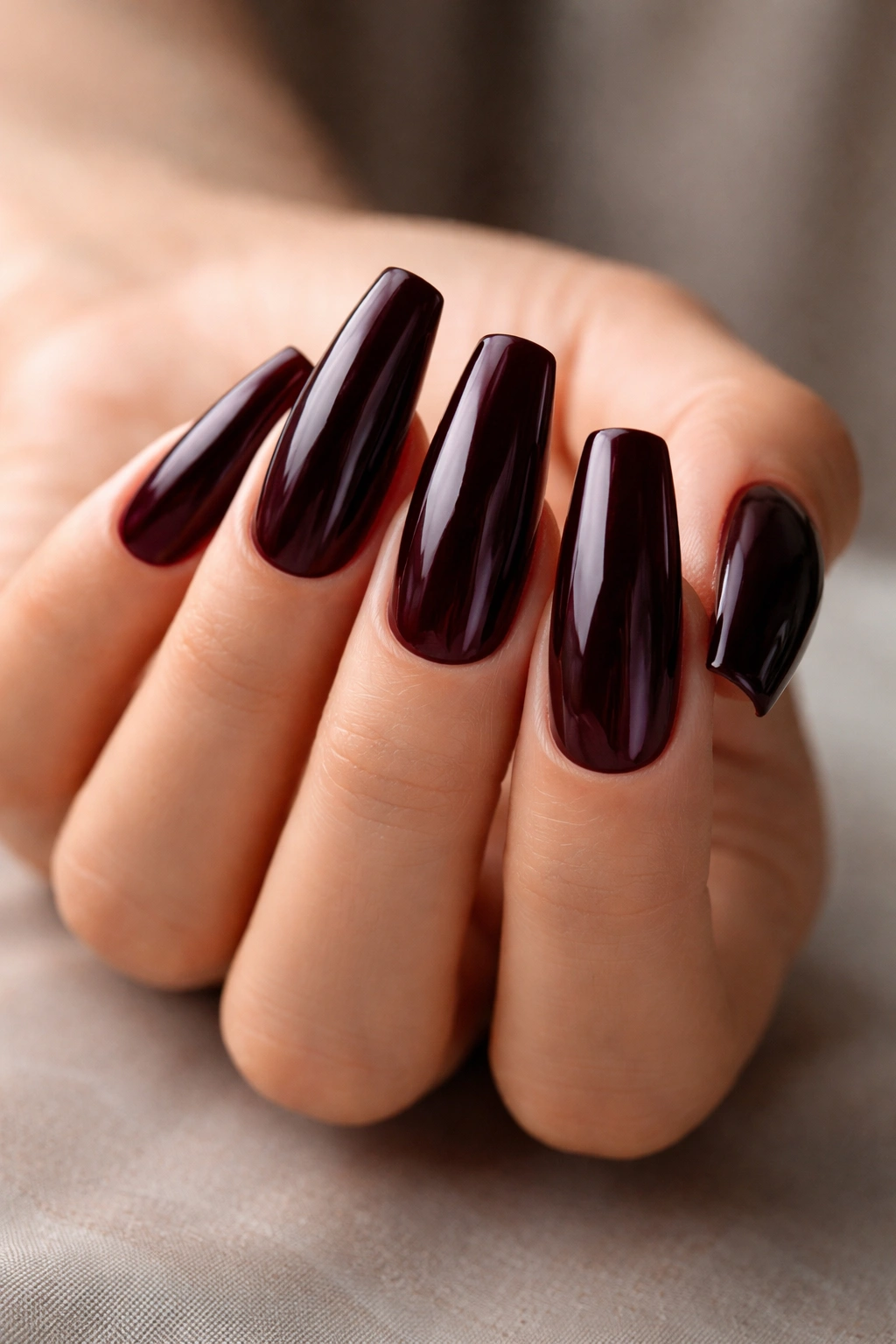 Ballerina nails in almost-black red with a glossy finish