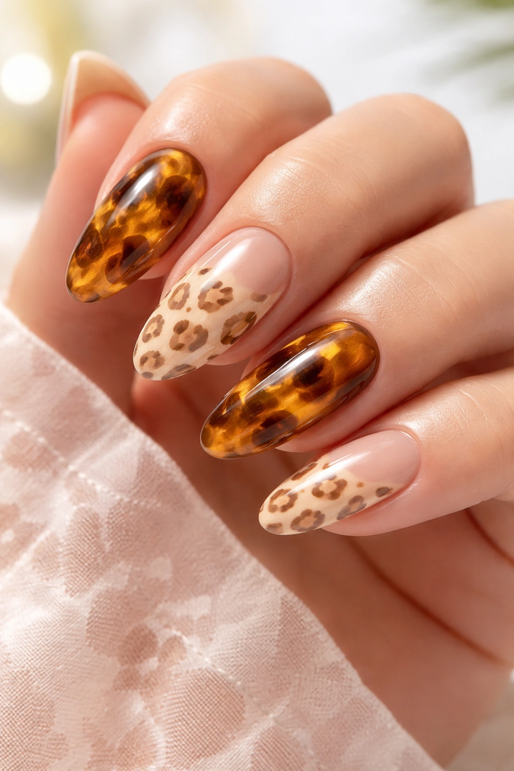 Nails with tortoise shell and leopard prints on sheer nude base