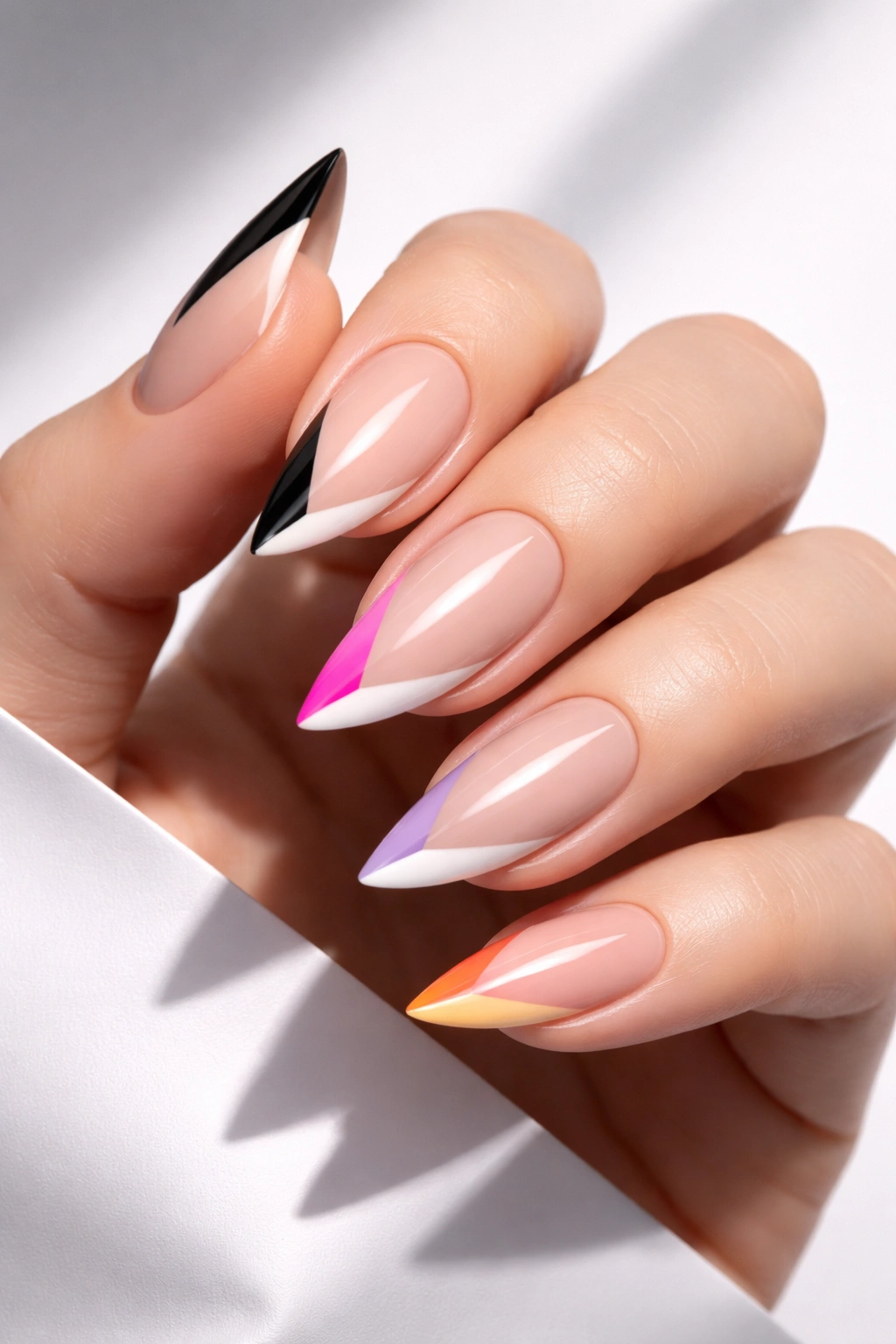 Close-up of hand with diagonal angular nail tips in two tones