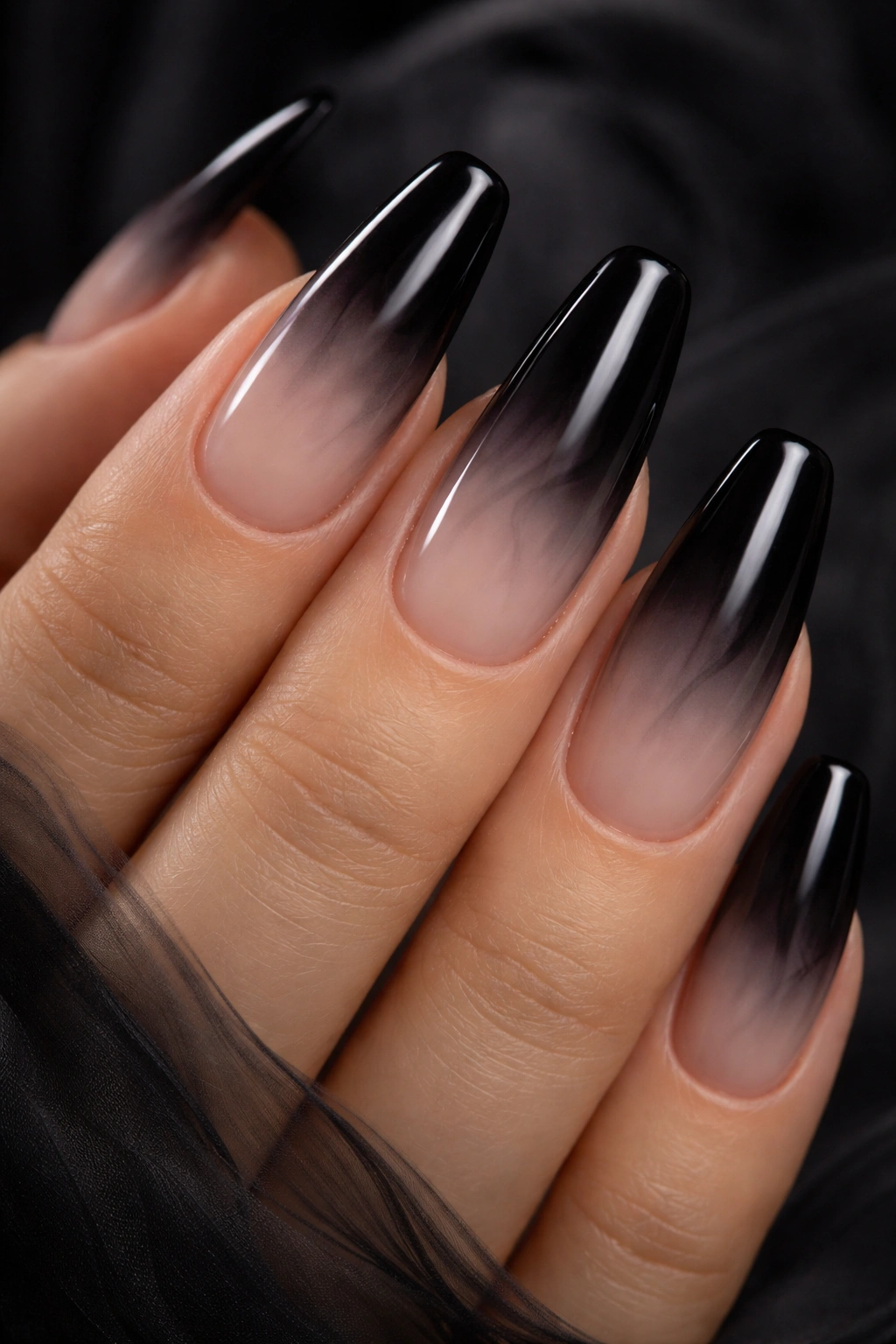 Close-up of black gradient aura nails on nude base