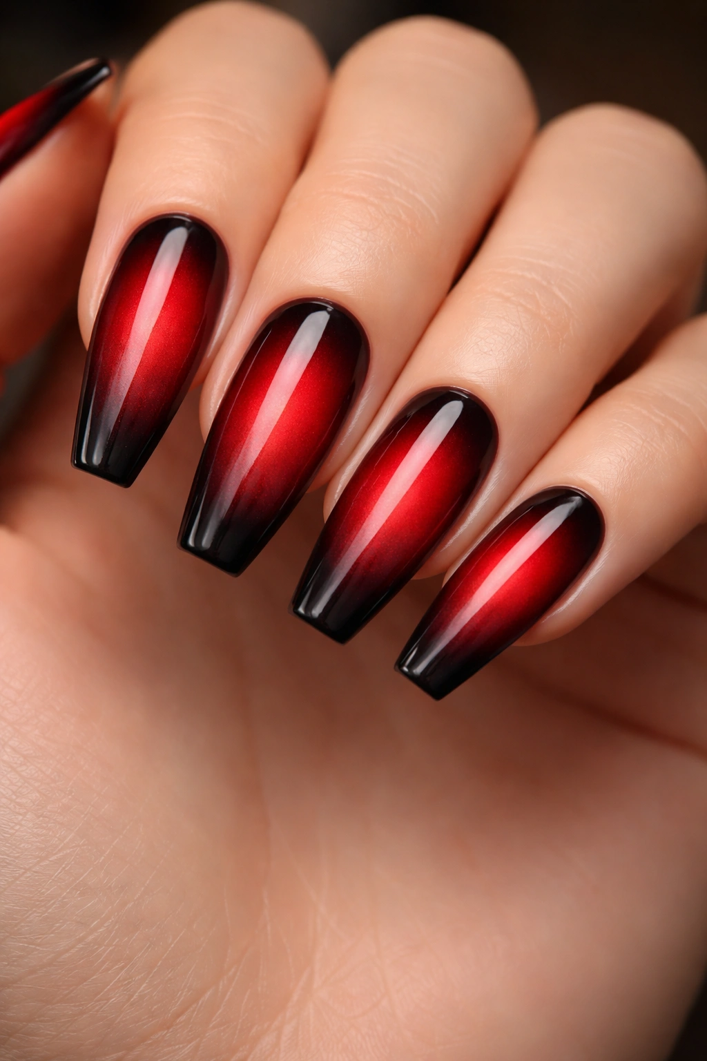 Crimson aura fade nails with black contour on ballerina nails.