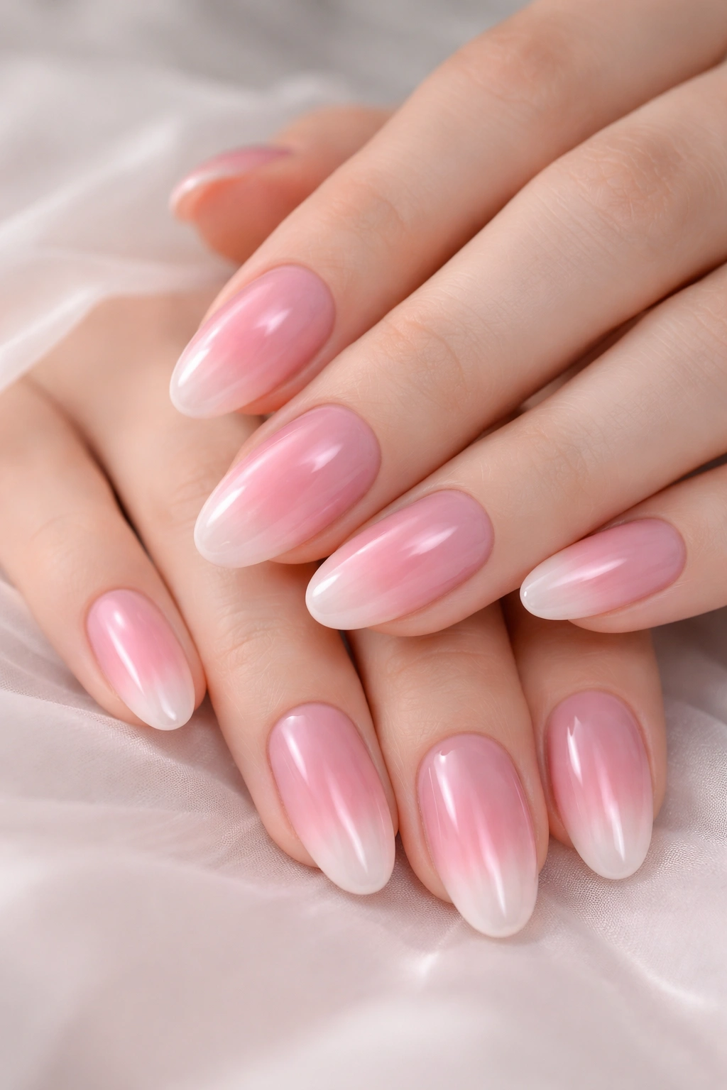 Close-up of pink aura nails with a central glow on hands